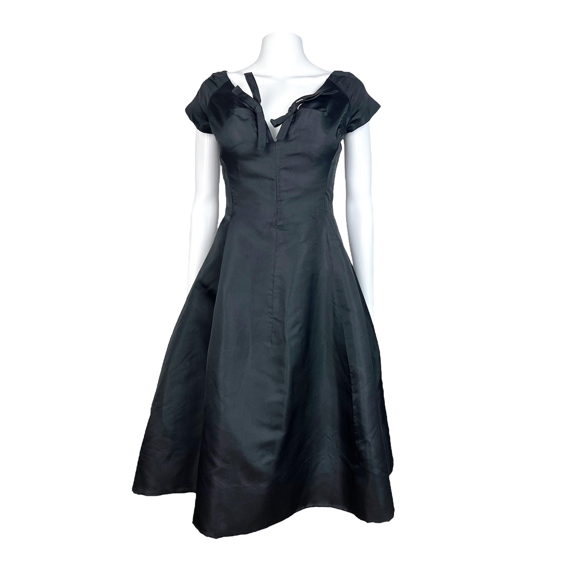 Exquisite and very rare Christian Dior by Yves Saint Laurent dress from 1958 . This dress is made out of a luxurious thick black silk and has a Christian Dior label that reads “ Patron Original”. The 
