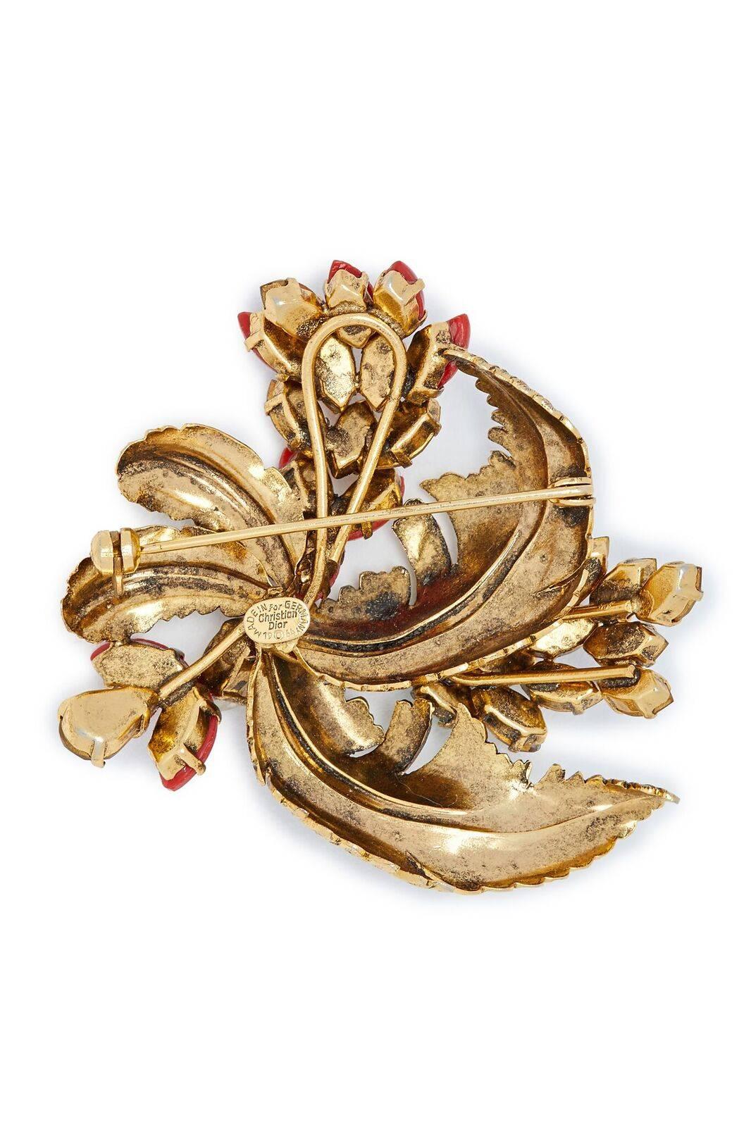 This desirable 1964 Christian Dior feather spray design brooch in burnished gold-tone metal is a timeless piece in excellent condition. Prong set navette cut faux gemstones in burnt orange, jade green, milk opal and brown topaz are artfully arranged
