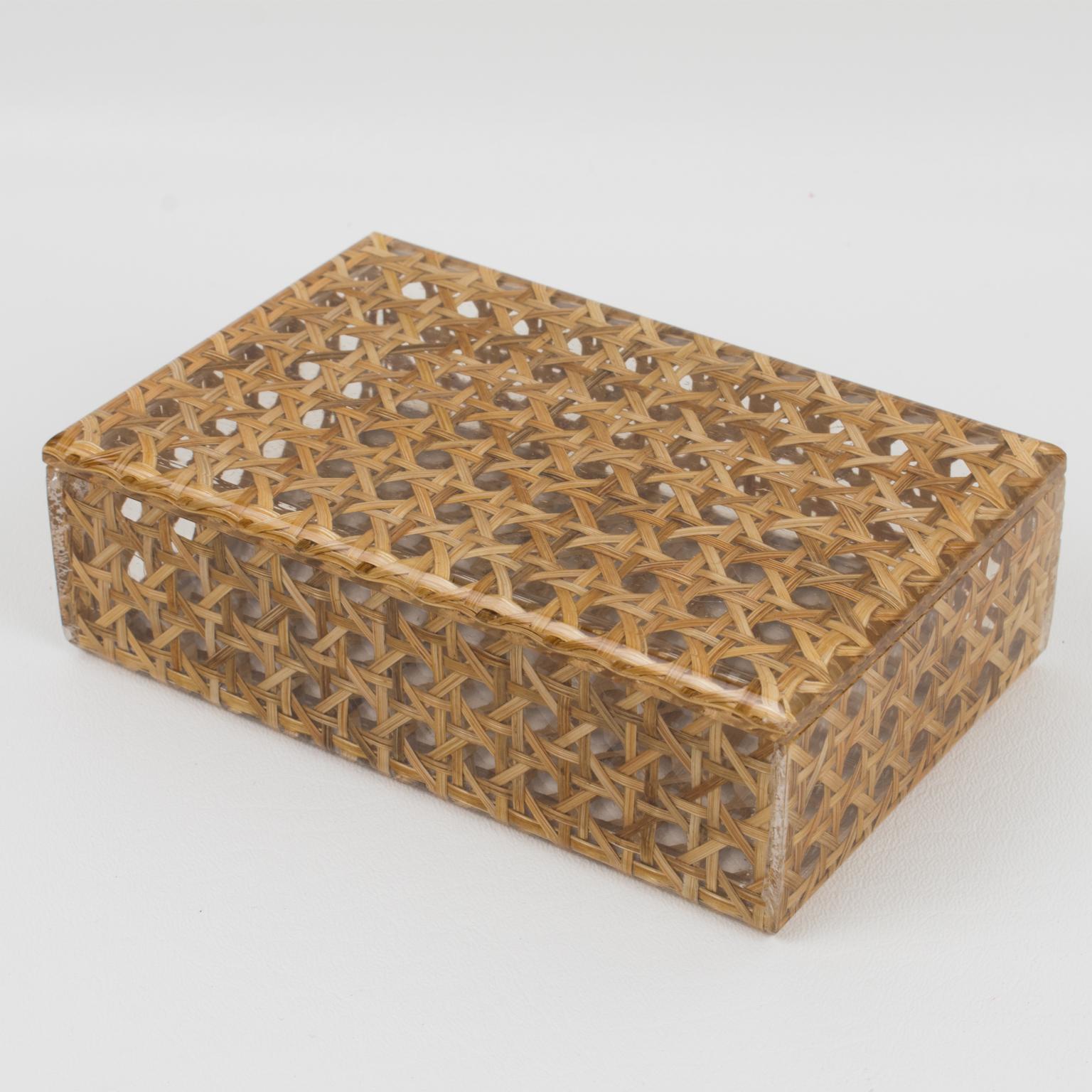 A charming 1970s Lucite decorative box designed for Christian Dior Home Collection. Large rectangular shape with real rattan (or wicker) cane work embedded in the crystal clear Lucite. Great accessory for any modern interior.
Measurements: 6.13 in.