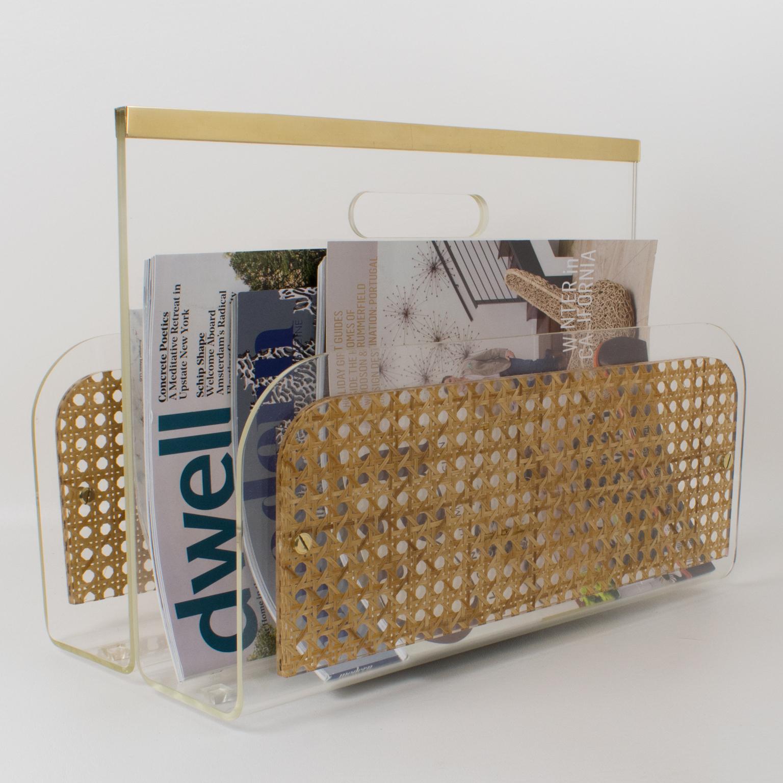 Stunning modernist magazine rack, holder, stand designed for Christian Dior Home Collection in the 1970s. Geometric shape with brass gallery, clear Lucite, and real rattan cane-work panels embedded in Lucite. Great accessory for any modern