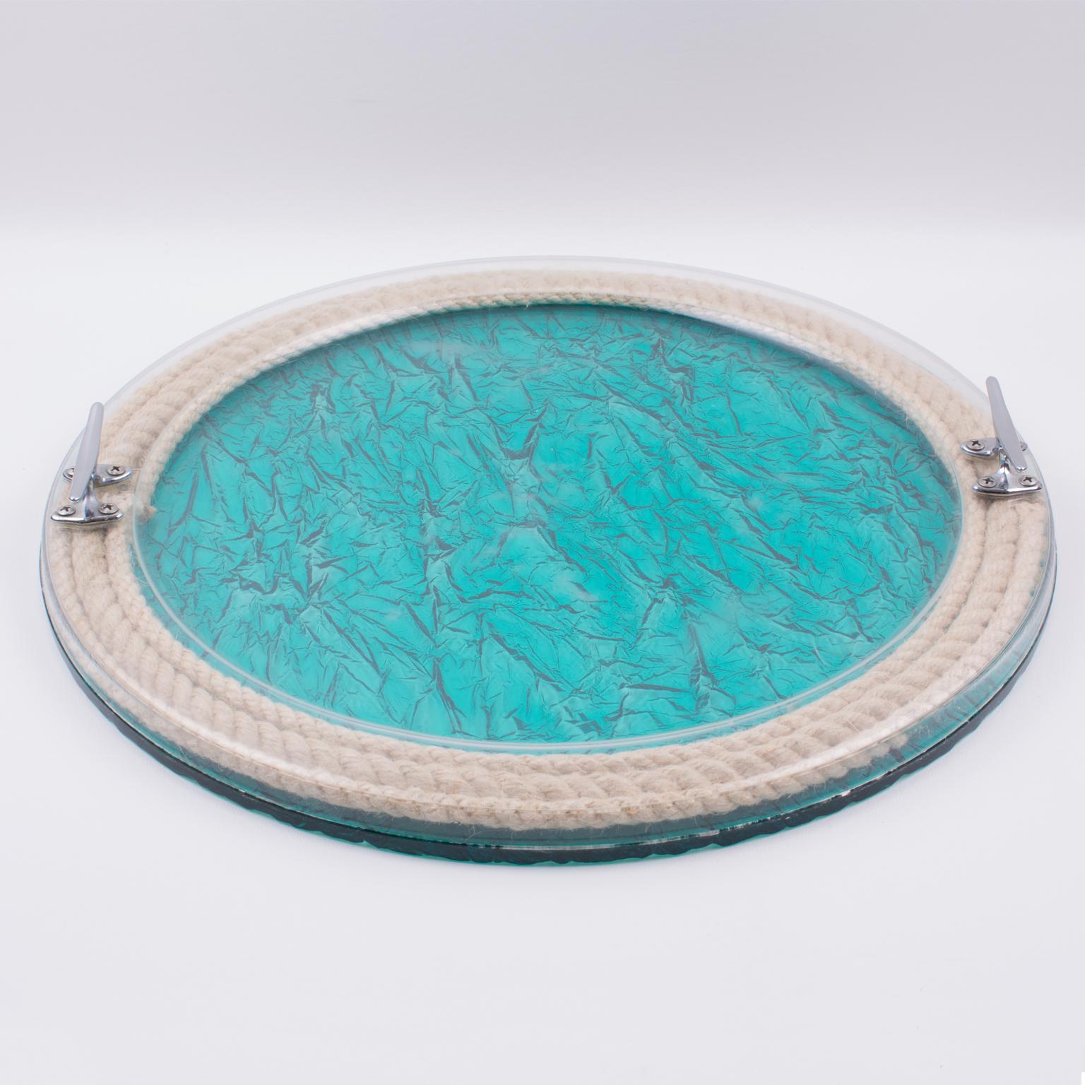 Elegant large barware serving tray designed for Christian Dior home collection, in the 1970s. Rounded shape with porthole design, featuring real rope embedded in the crystal clear Lucite, with chromed metal handles in a boat-fittings-like shape and