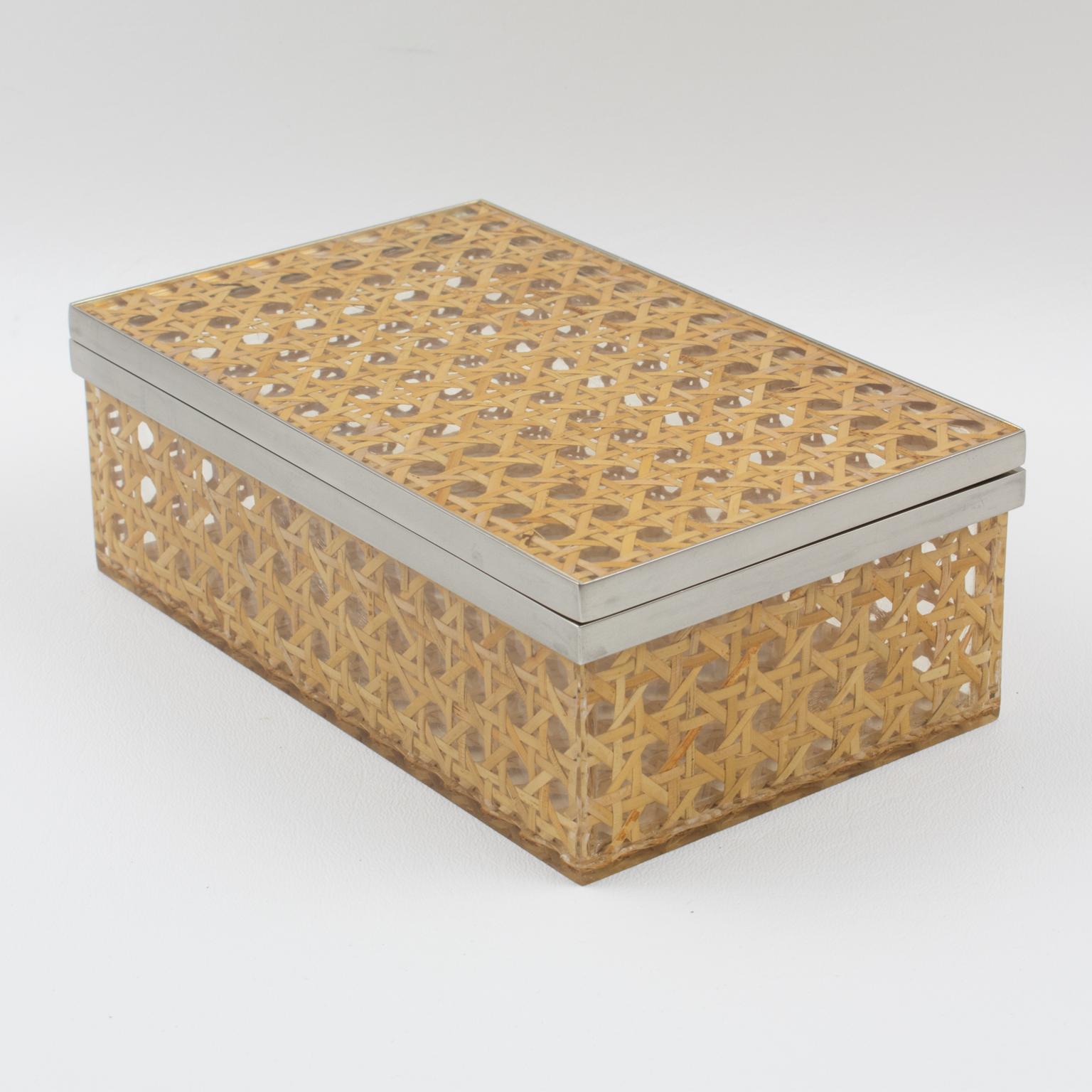 A charming modernist 1970s Lucite decorative box designed for Christian Dior Home Collection. Large rectangular shape with real rattan (or wicker) cane work embedded in the crystal clear Lucite and chromed metal hardware. Great accessory for any