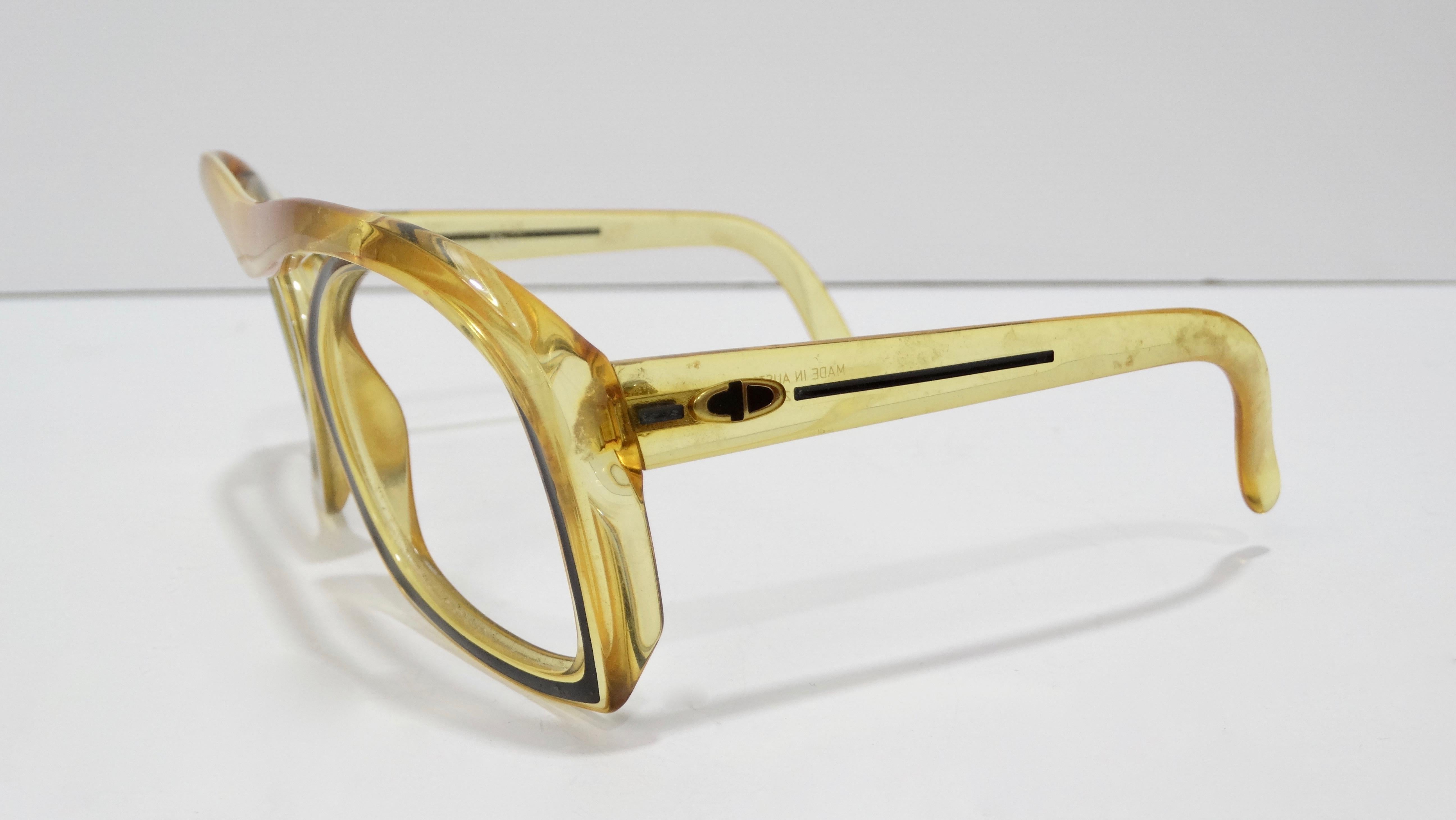 Make a statement with these Dior glasses! Circa 1970s, these glasses feature an oversized amber colored butterfly frame with a black trim around the eyes. On both arms is a small 