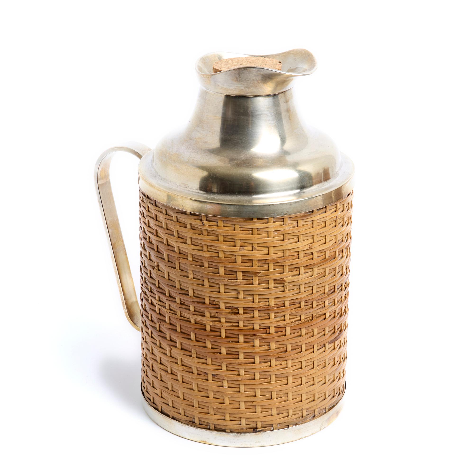 Christian Dior Maison picnic set in silver metal partially covered with wicker composed of a thermos for tea, a second for coffee and a bottle cooler. Dimensions of the 3 pieces - Tea thermos: height 25 cm x diameter 14.5 cm - Coffee thermos: height