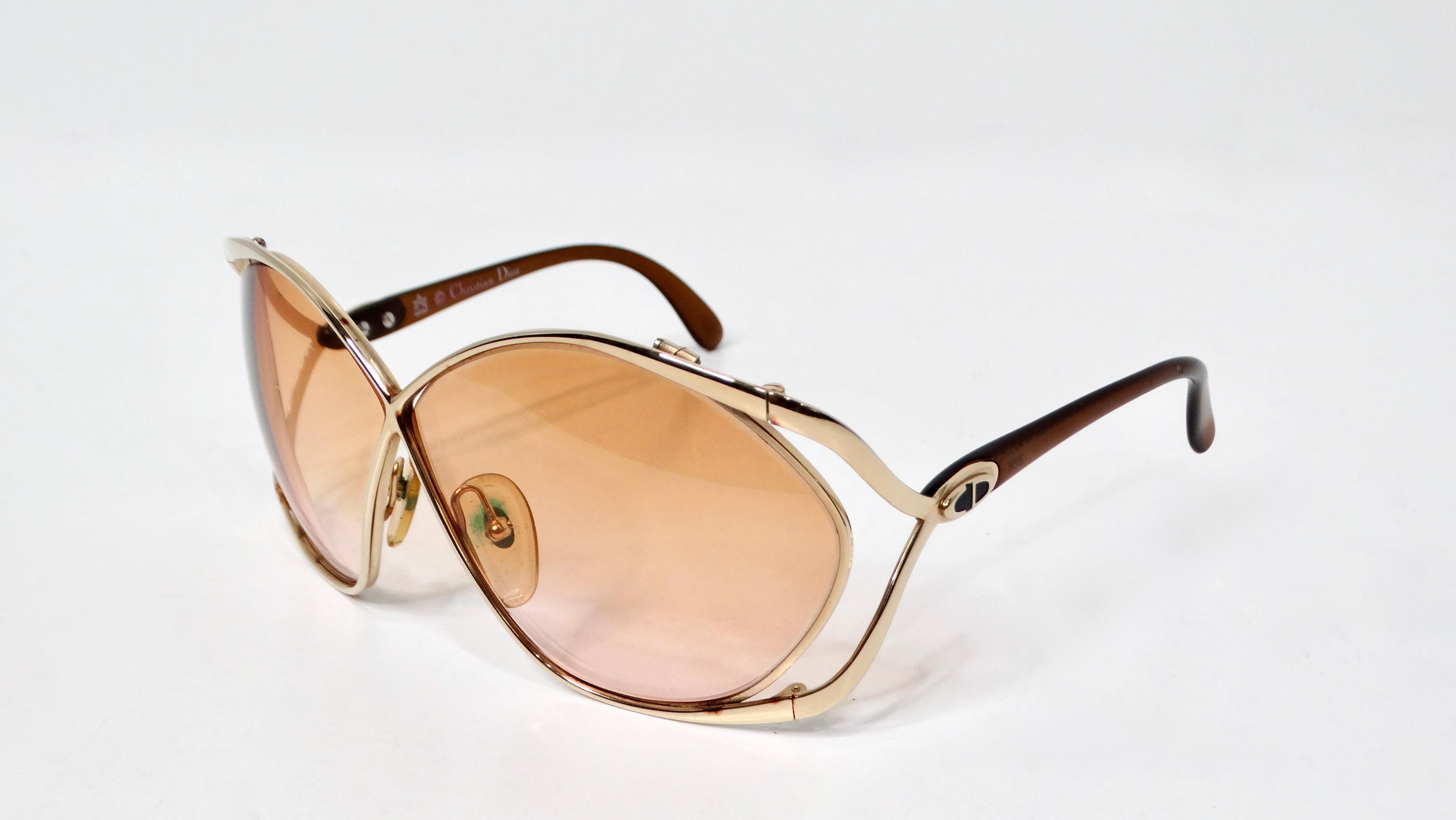 Step into a world of vintage glamour with the Christian Dior 1980s Butterfly 2056 Orange Gradient Tinted Lens Sunglasses. These elegant sunglasses are framed with luxurious gold-tone metal that adds a touch of opulence to any outfit. The striking