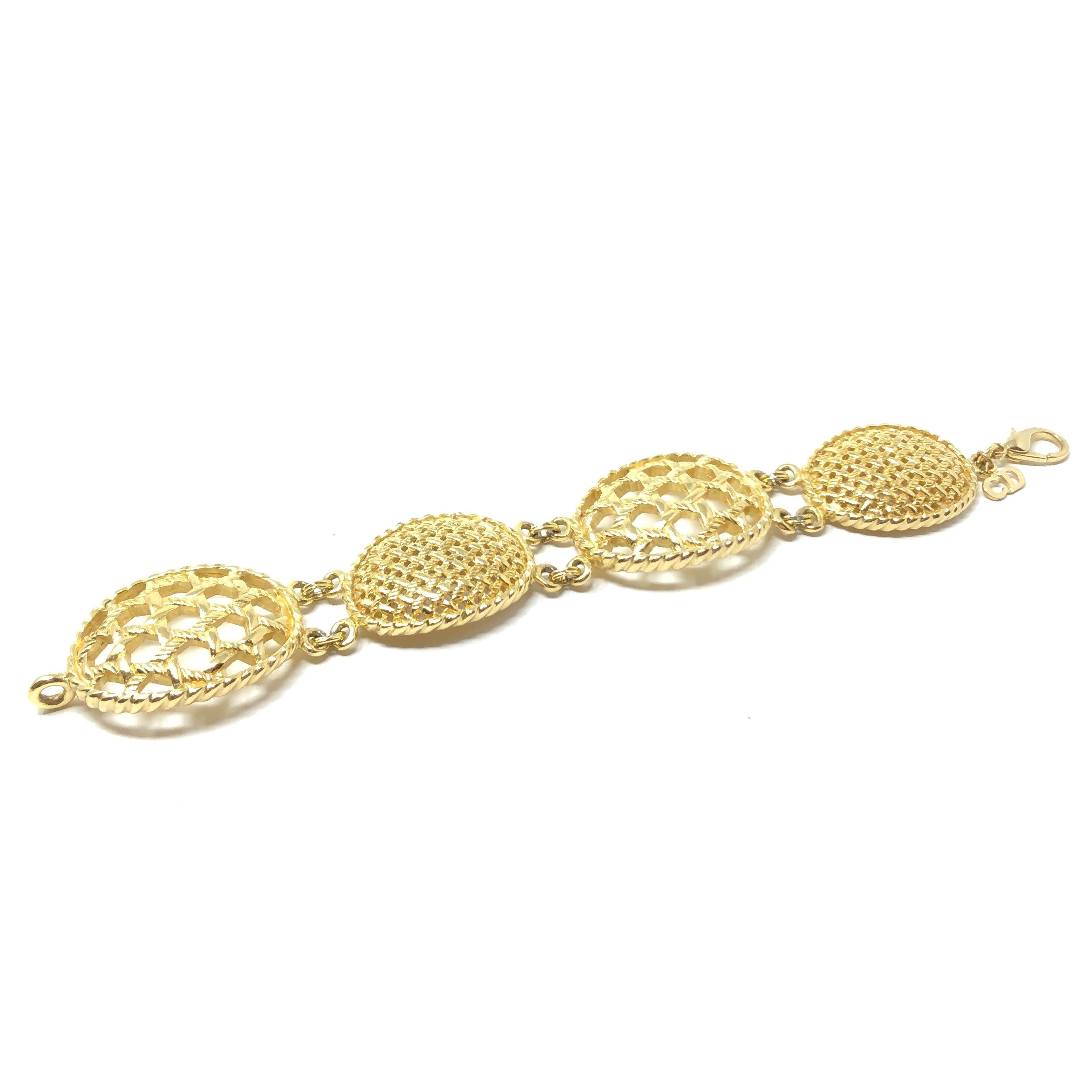 This chic bracelet is a lovely example of Christian Dior's 1980s gold plated jewellery.

Condition Report:
Excellent

The Details...
This gold plated bracelet features 4 crinkle edged ovals detailed with Dior’s signature ‘cannage’ design in two