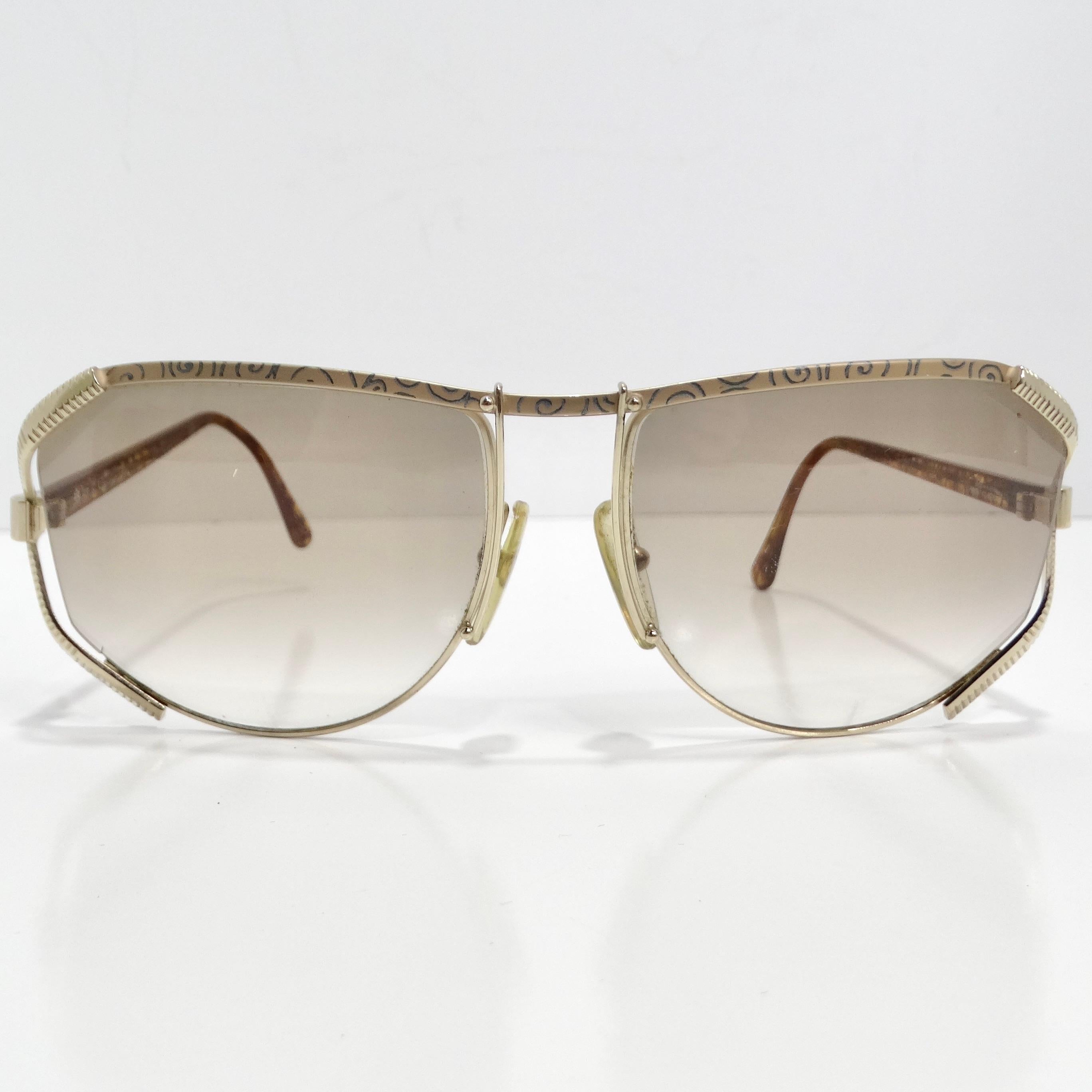 Introducing the Christian Dior 1980s Gold Tone Aviator Sunglasses, a stunning vintage piece that encapsulates the glamour and sophistication of the era. These iconic sunglasses boast a timeless aviator silhouette with exquisite detailing that exudes