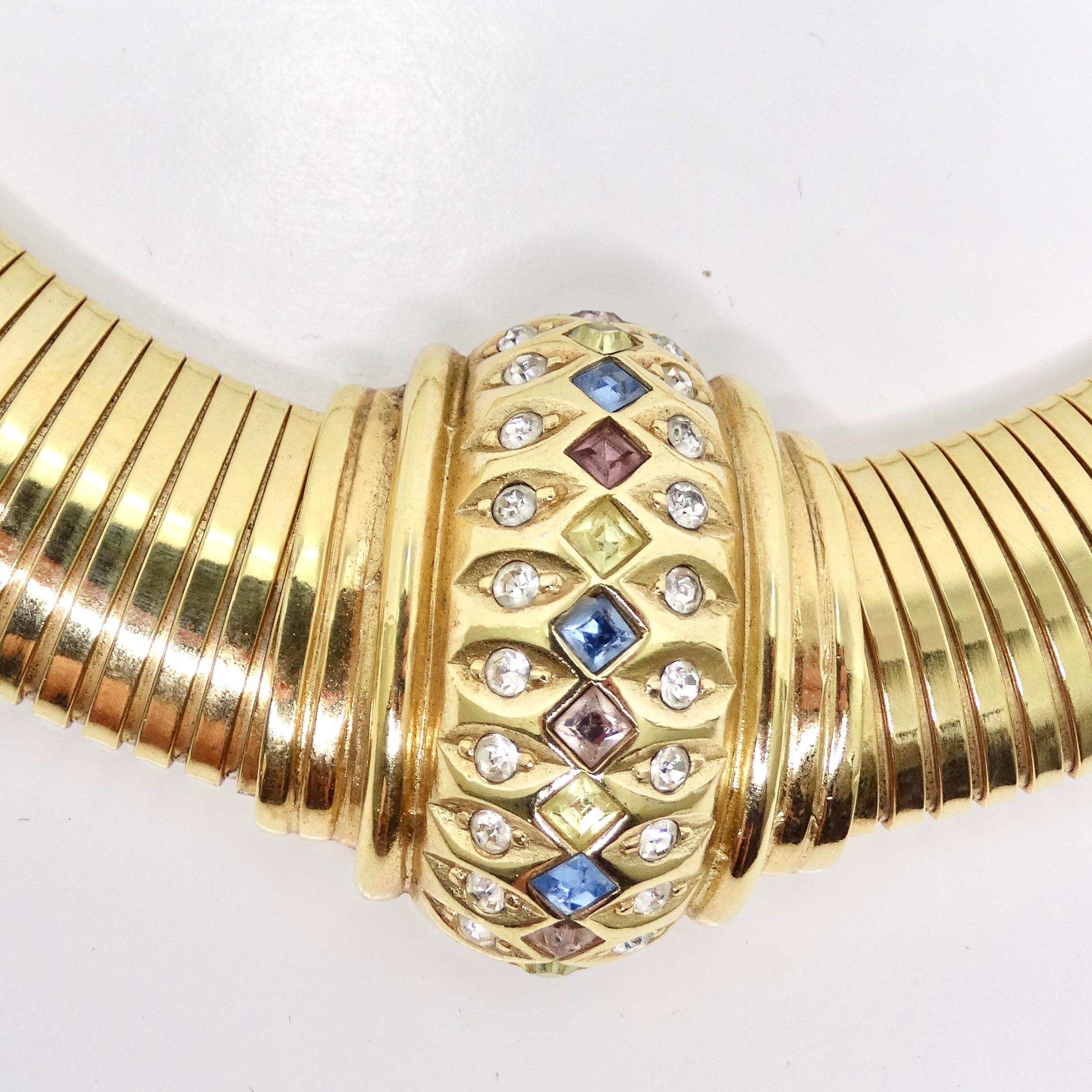 Introducing the Christian Dior 1980s Gold Tone Omega Rhinestone Choker, a stunning piece that encapsulates the glamour and elegance of the 1980s. Crafted with exquisite attention to detail, this omega style gold tone choker features a flat and