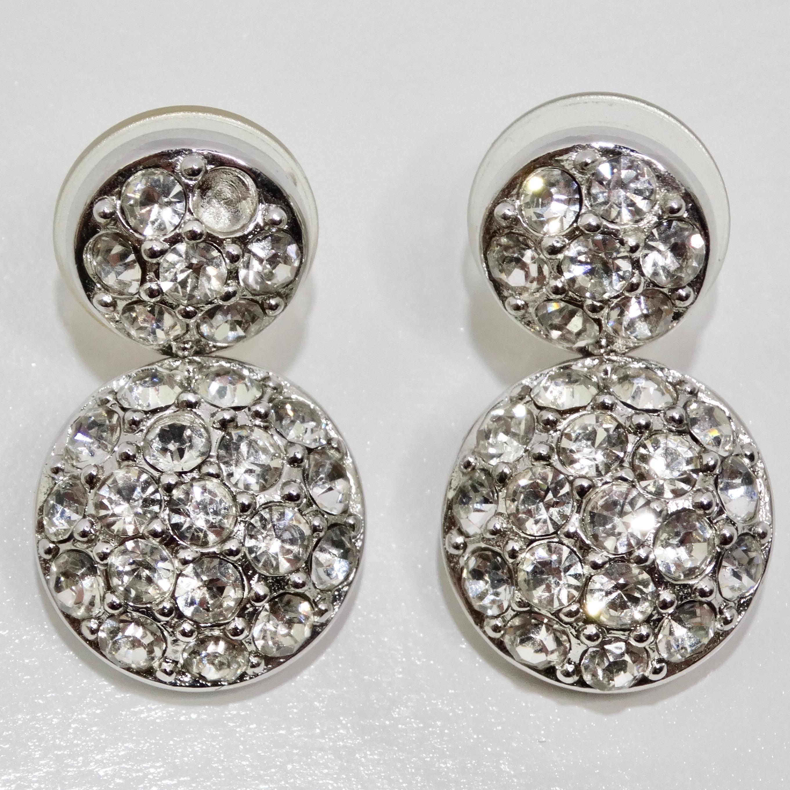 Elevate your style with the Christian Dior 1980s Rhinestone Dangle Earrings, a delightful vintage pair that adds a perfect touch of glamour to any look. These exquisite earrings feature two silver-plated circles that dangle elegantly, each adorned