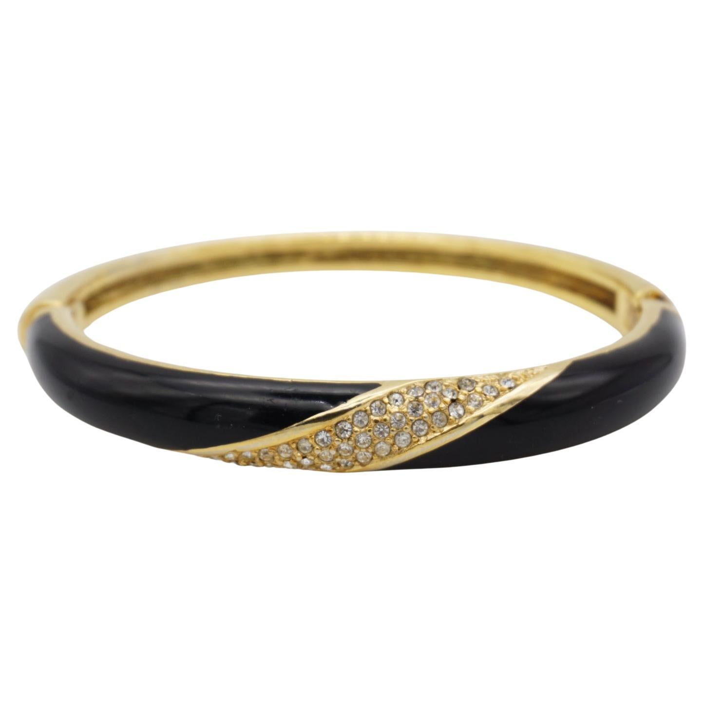 Christian Dior 1980s Vintage Black Enamel Spiral Crystals Cuff Bangle Bracelet, Gold Tone

A very beautiful bracelet by Chr. DIOR, signed at the back. Rare to find. 

Very good condition. 100% Genuine.

Size: diameter 6.5 cm. perimeter 20 cm. width: