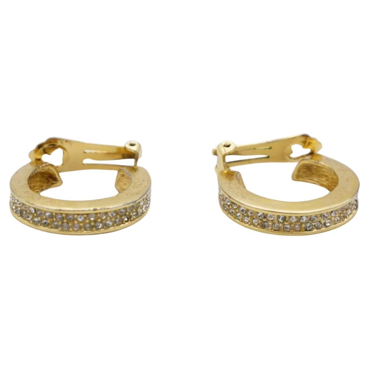 Christian Dior 1980s Vintage Circle Double Crystals Huggie Hoop Clip Earrings, Gold Tone.

Good condition. 100% Genuine. All stones are attached, but some darken or turn green.

Signed 