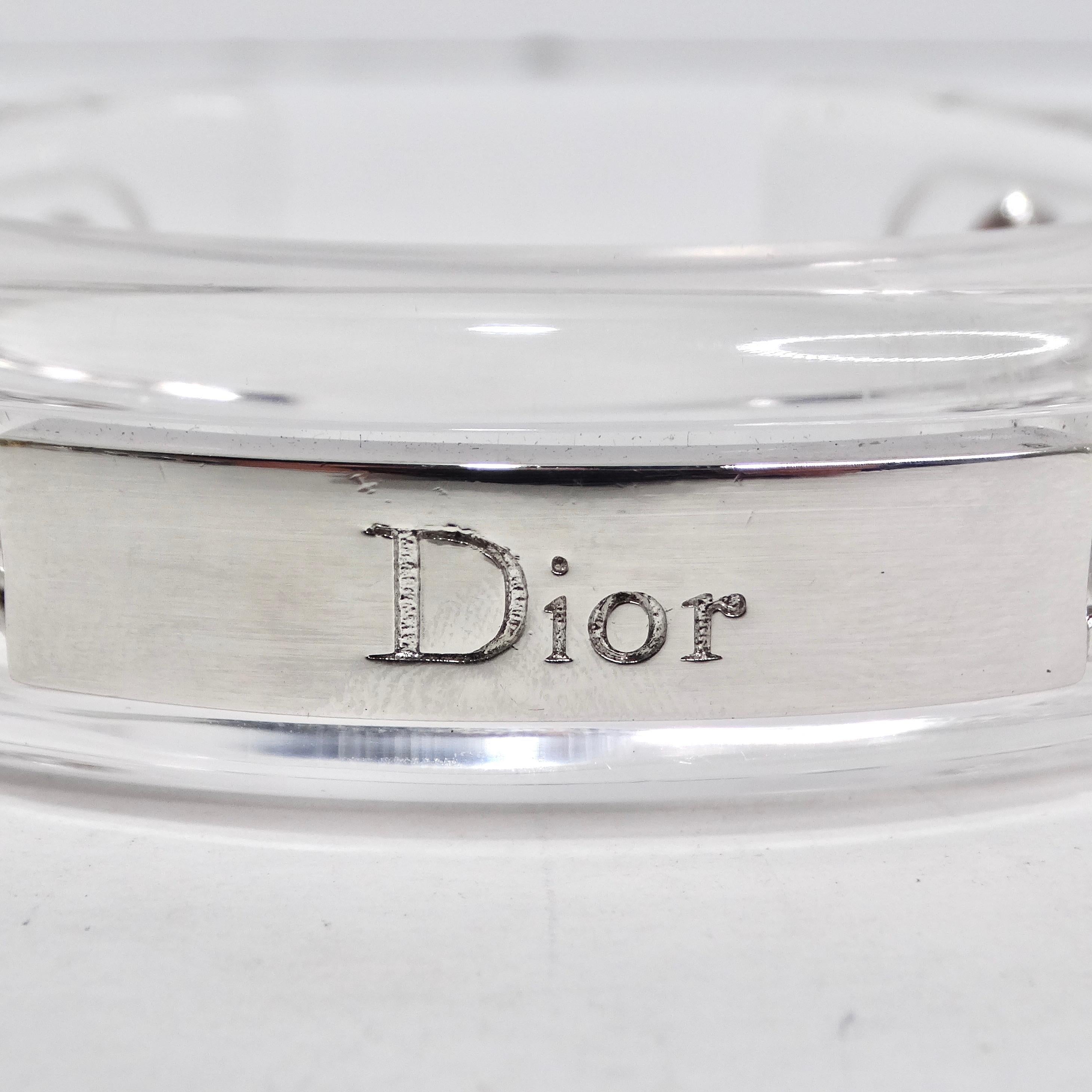 Indulge in the allure of vintage luxury with the Christian Dior 1990s Chain Lucite Cuff Bracelet—an accessory that transcends the boundaries of fashion and becomes a unique statement piece. Imagine adorning your wrist with a clear plexiglass cuff, a