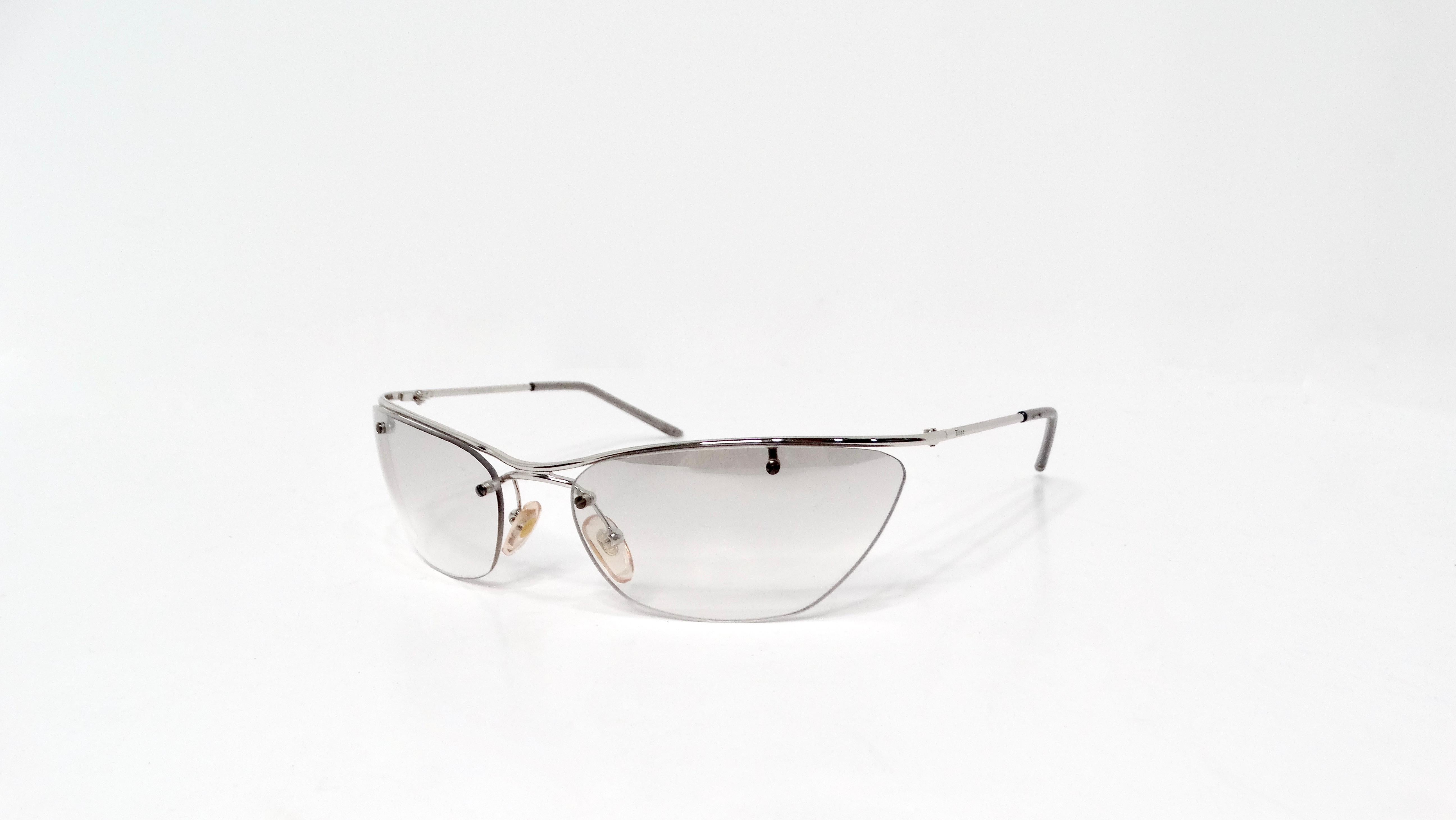 Embrace the spirit of vintage luxury with the Christian Dior 1990s Flash Grey Tinted Lens Sunglasses, an iconic accessory that effortlessly combines retro charm with modern flair. These sunglasses feature striking grey tinted lenses that provide a