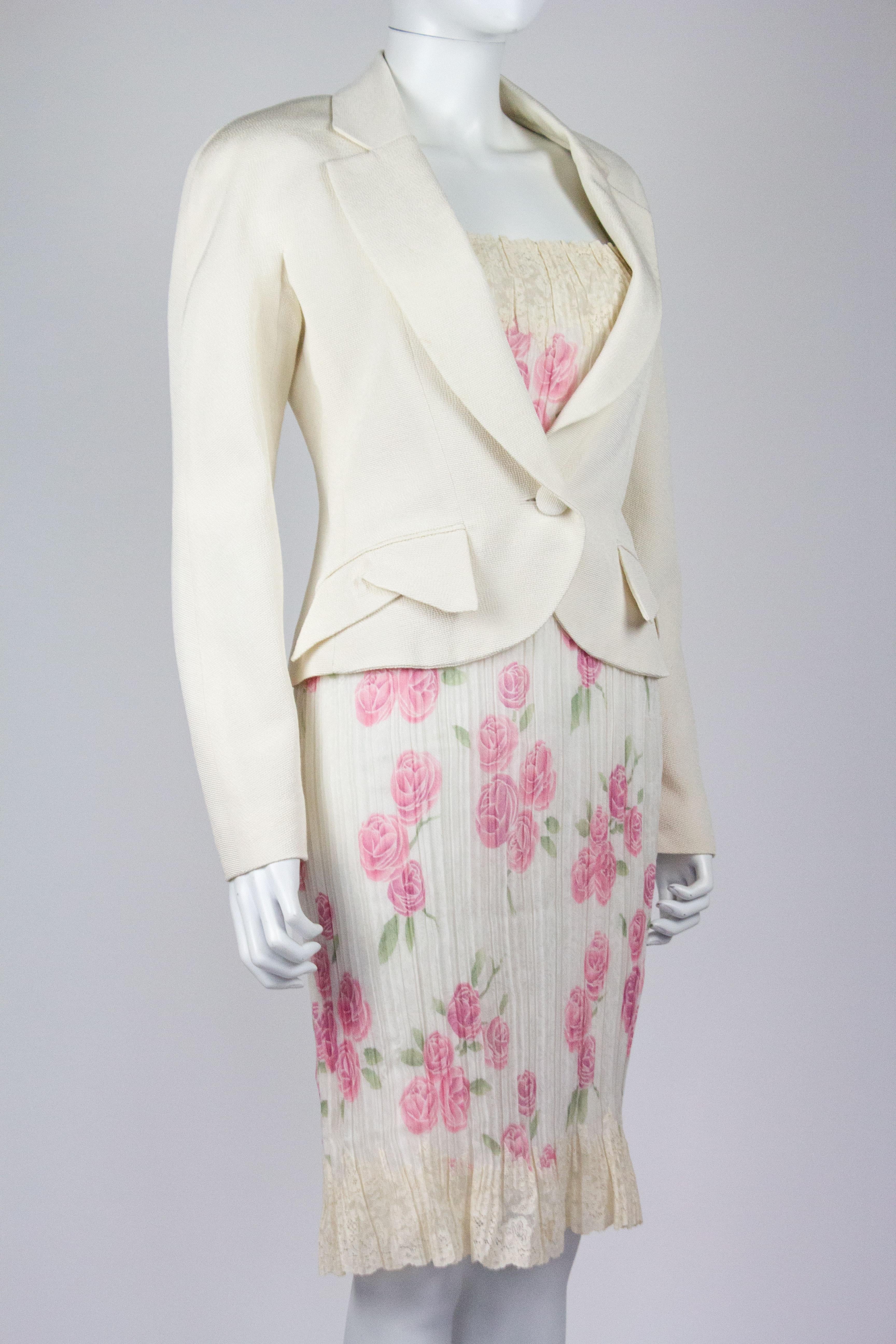 Christian Dior by John Galliano dress and jacket set, from the Spring/Summer 1999 collection. Consists of a rose printed plisse dress with beaded straps and lace hem, with a beautifully tailored white jacket.

Condition
Dress: Very good, small mark