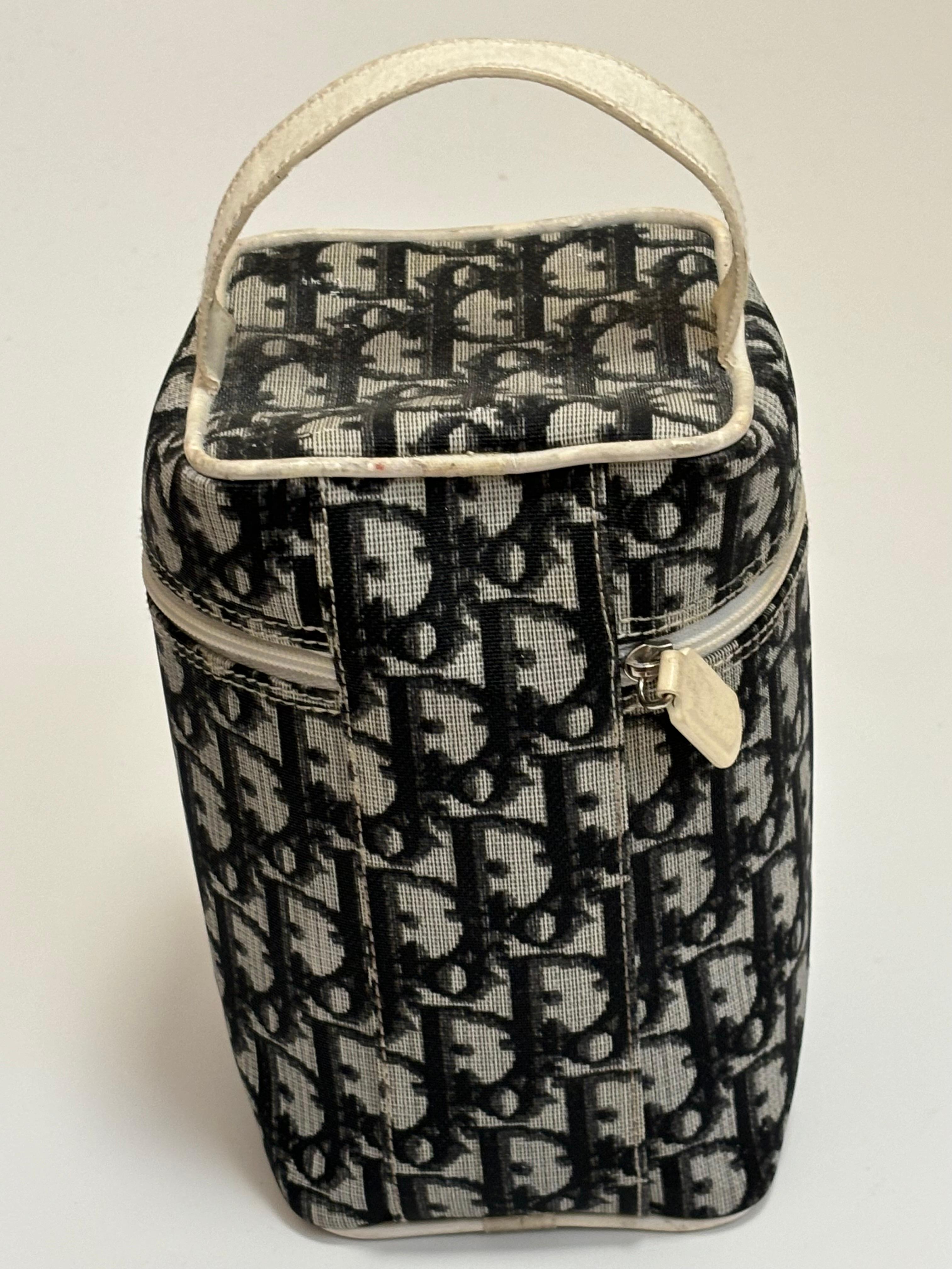 Use it as a make-up bag, jewelry case , or carry as a hand bag. This is a rare and unique canvas and leather, blue and white, trotter pattern bag with model #CM0018.
There is a zip around cap with a Christian Dior inscribed pull; a cloth lining and