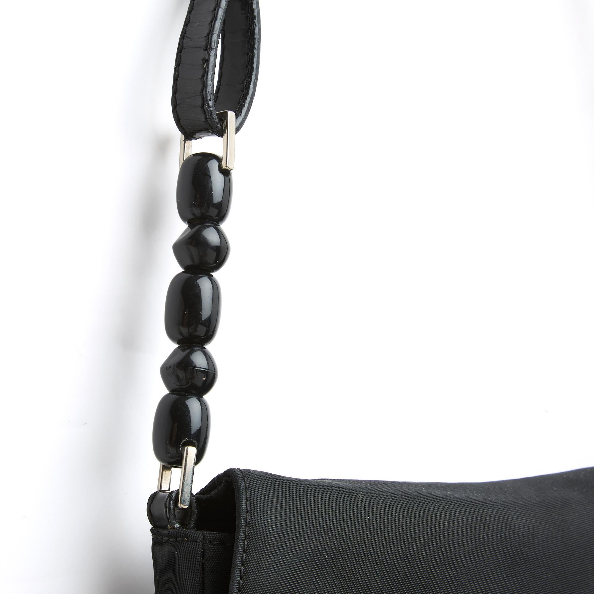 Christian Dior Malice bag circa 2000 by John Galliano Mini format in black ottoman (probably technical nylon thread), large front flap with openwork pattern circled in silver metal encrusted with baguette rhinestones, underneath, patent leather
