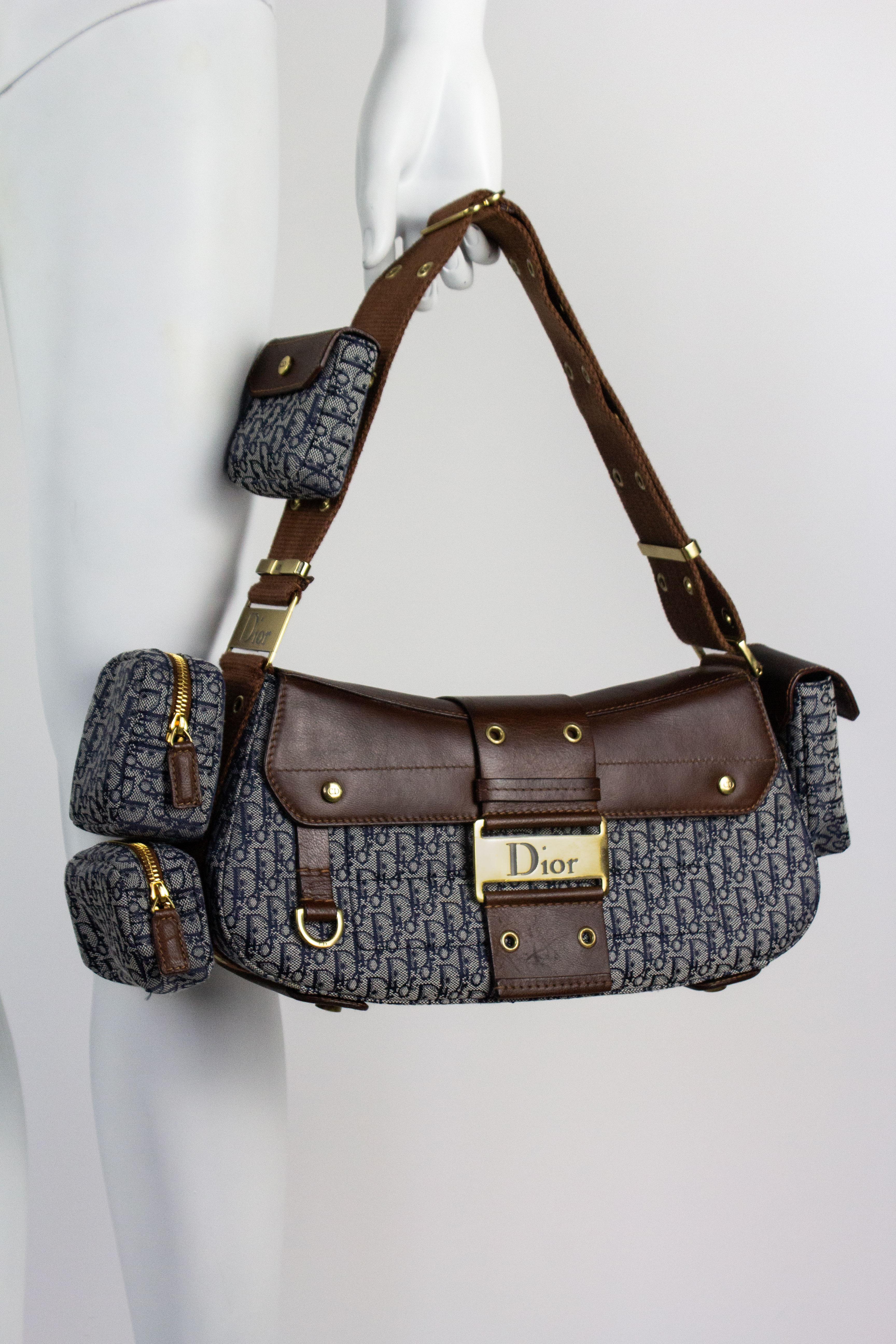 Vintage Christian Dior Columbus handbag, designed by John Galliano. Featured on the 2002 runway. Brown leather with navy monogram patterned canvas and gold toned hardware. Complete with all of its original detachable pockets.

Condition
Excellent.