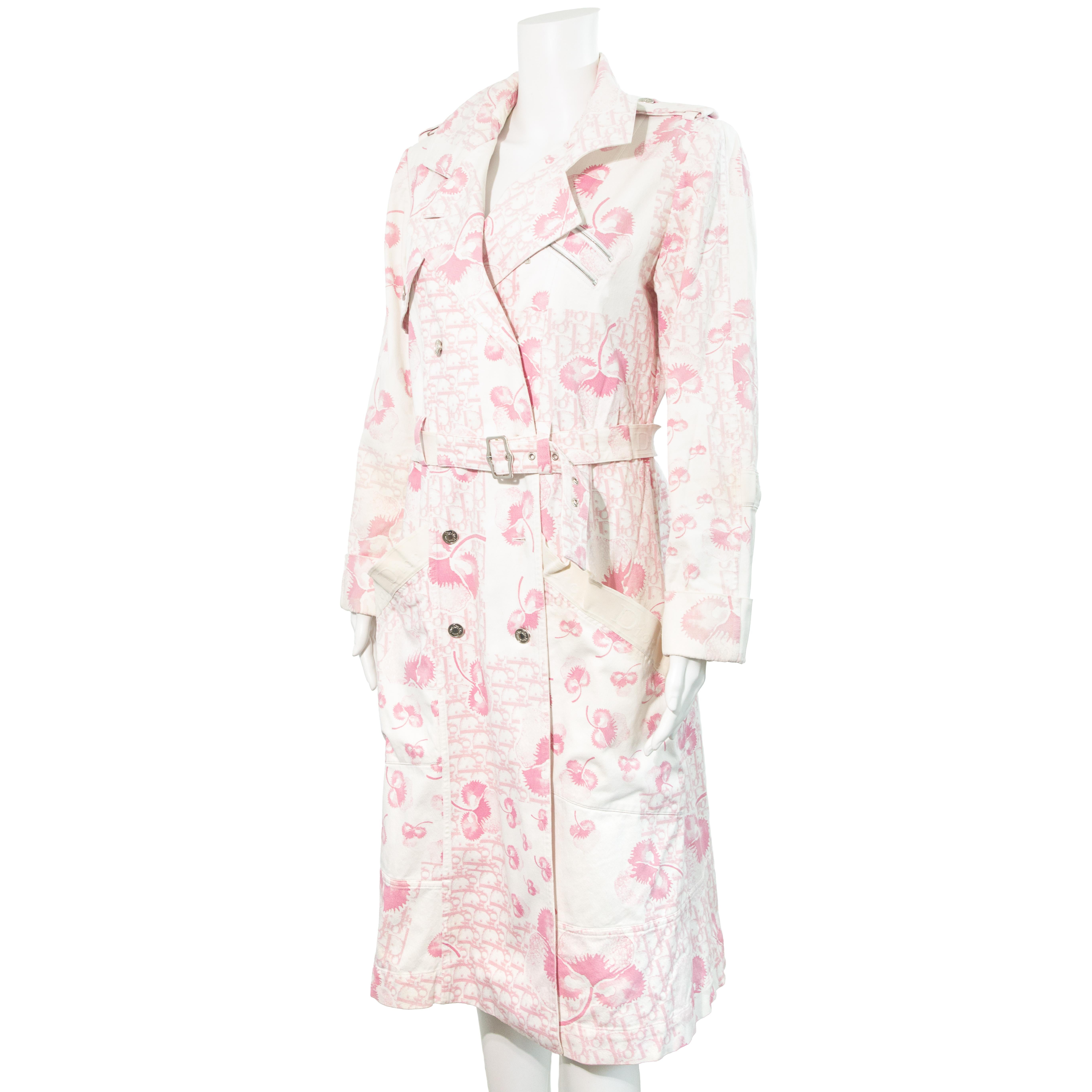 Ruder Than The Rest presents an elusive Christian Dior 2005 Blossom monogram print knee length trench coat.

Designed by John Galliano.

Pink and white blossom monogram print.

Classic oversized trench coat silhouette with shoulder pads.

Raised