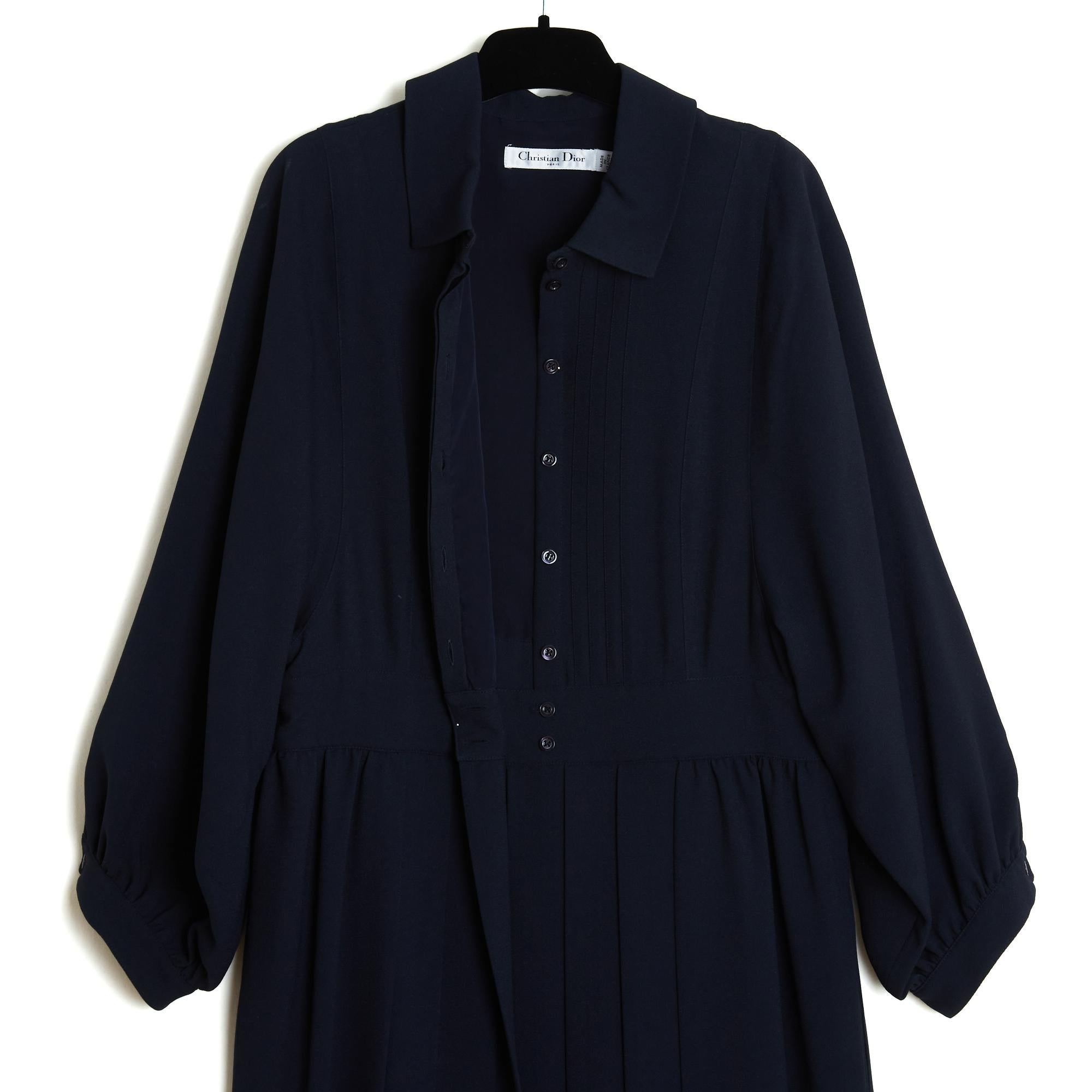 Christian Dior dress circa 2017 in navy blue wool cloth, collar closed by 8 coordinated buttons including 7 hidden and 2 snaps at the waist, stitched pleats on the bib, small free pleat on the front of the skirt and flat pleats on the back, 3/4