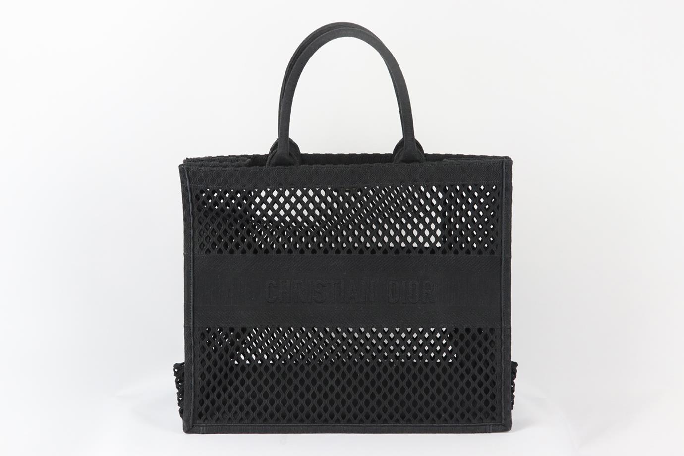 Christian Dior 2020 Book large jacquard cutout canvas tote bag. Made from black cutout canvas design with the brand's iconic logo on the front, it opens to a large internal compartment. Black. Open top. Does not come with dustbag or box. Width: 16.5