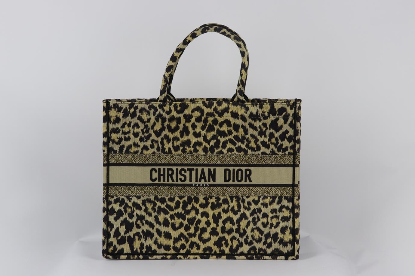 Christian Dior 2021 Book large leopard jacquard canvas tote bag. Made from black, gold and brown leopard design with the brand's iconic logo on the front, it opens to a large internal compartment. Black, gold and brown. Open top. Does not come with
