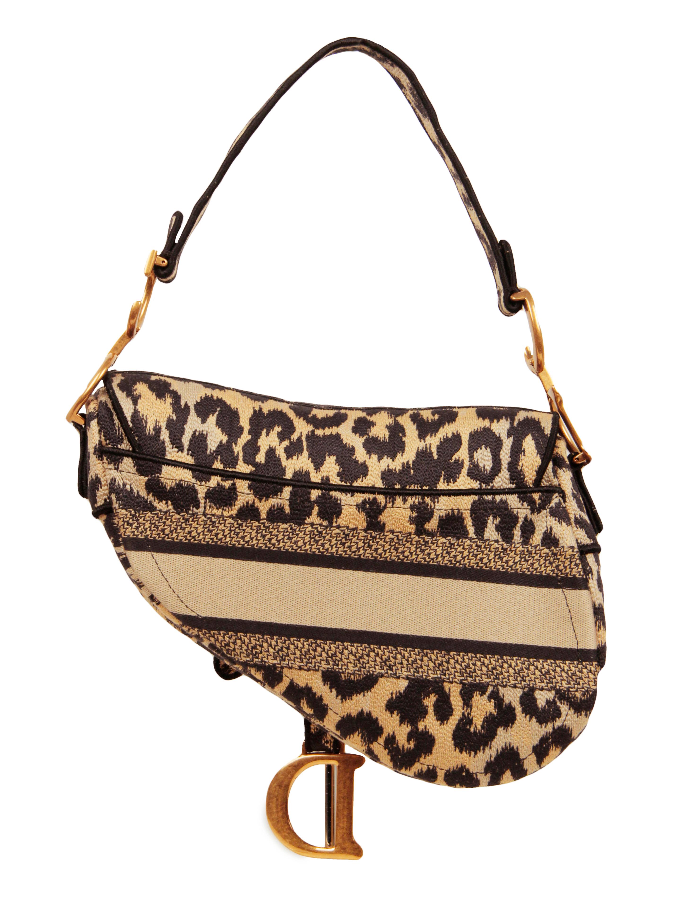 Christian Dior 2021 Beige/Brown Mizza Embroidery Leopard Print Saddle Bag

Made In: Italy
Year of Production: 2021
Color: Brown, beige, black
Hardware: Goldtone
Materials: Canvas
Lining: Unlined
Closure/Opening: Top flap with magnetic