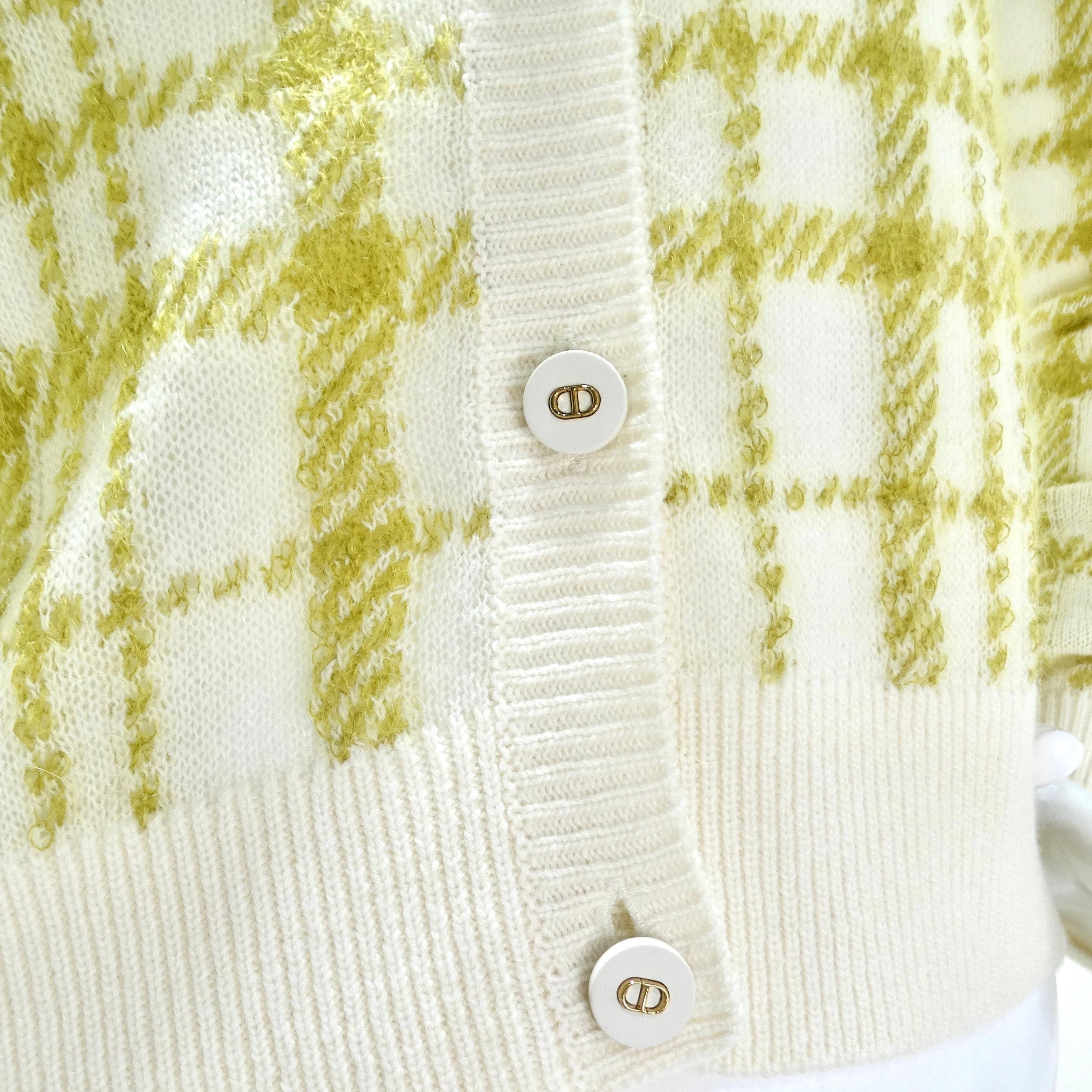 Wrap yourself in luxury with the Christian Dior 2021 Plaid Wool Cardigan – a classic and vibrant piece that effortlessly combines style and comfort. Crafted from yellow tone lime green and white plaid in a luxurious wool knit, this cardigan is a