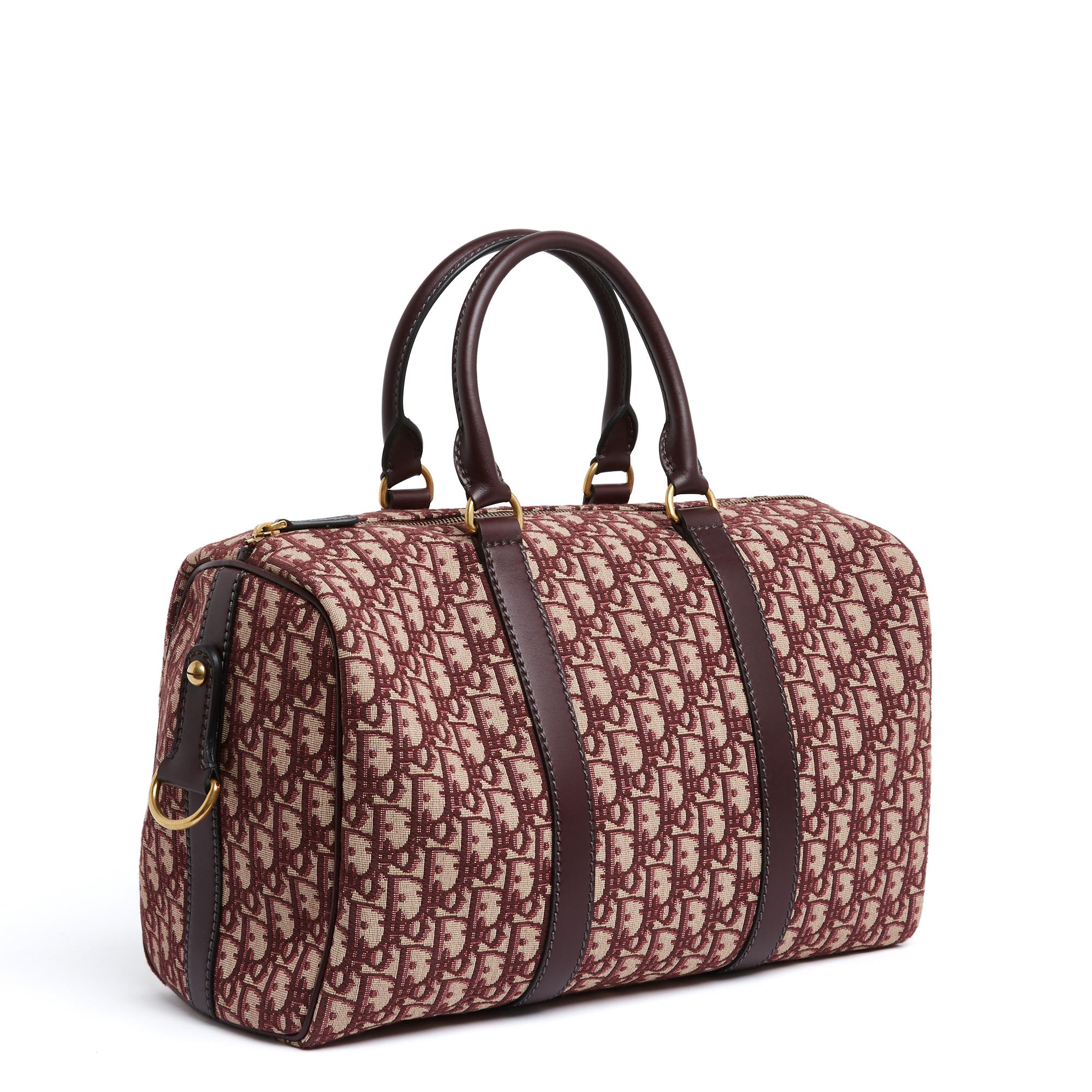 Christian Dior Bowling or Groove bag (in 2025) size 40 in burgundy Dior Oblique jacquard canvas and matching leather, ecru canvas interior with a large zipped pocket, bag closure with a gold metal zip with leather pull, 2 rings on leather tab, on