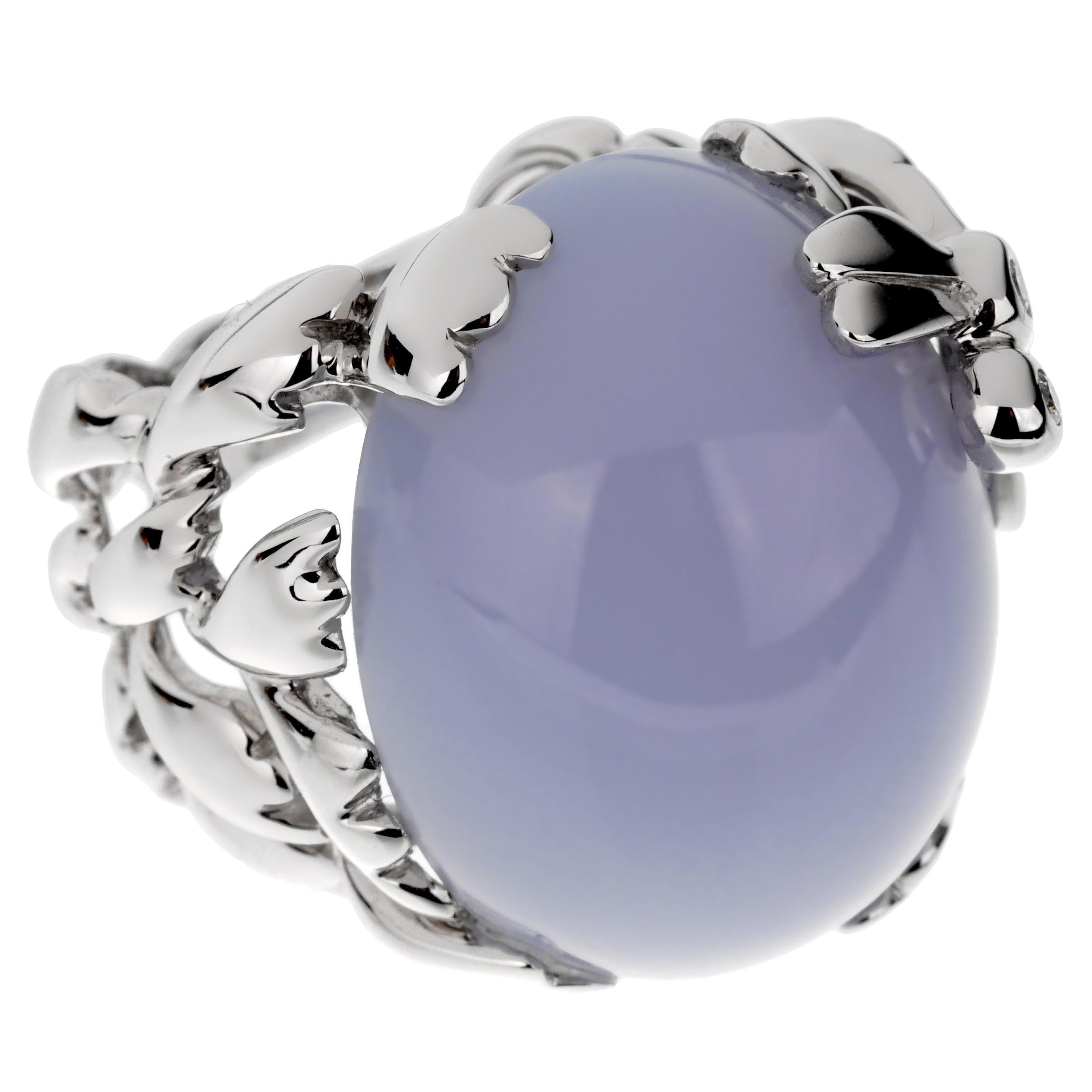 A magnificent cocktail ring by Christian Dior boasting a 40ct blue chalcedony wrapped by a white gold dragon fly adorned with 2 of the finest round brilliant cut diamonds in shimmering 18k whiite gold. The ring measures a size 52 euro and can be