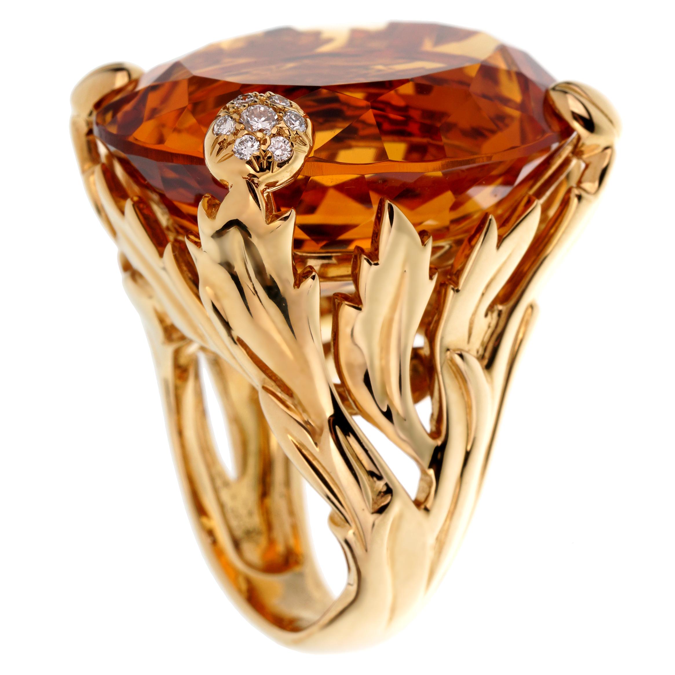 An incredible Christian Dior cocktail ring showcasing a 44.5ct oval citrine adorned by .12ct of the finest round brilliant cut diamonds in 18k yellow gold. The ring measures a size 53 eu