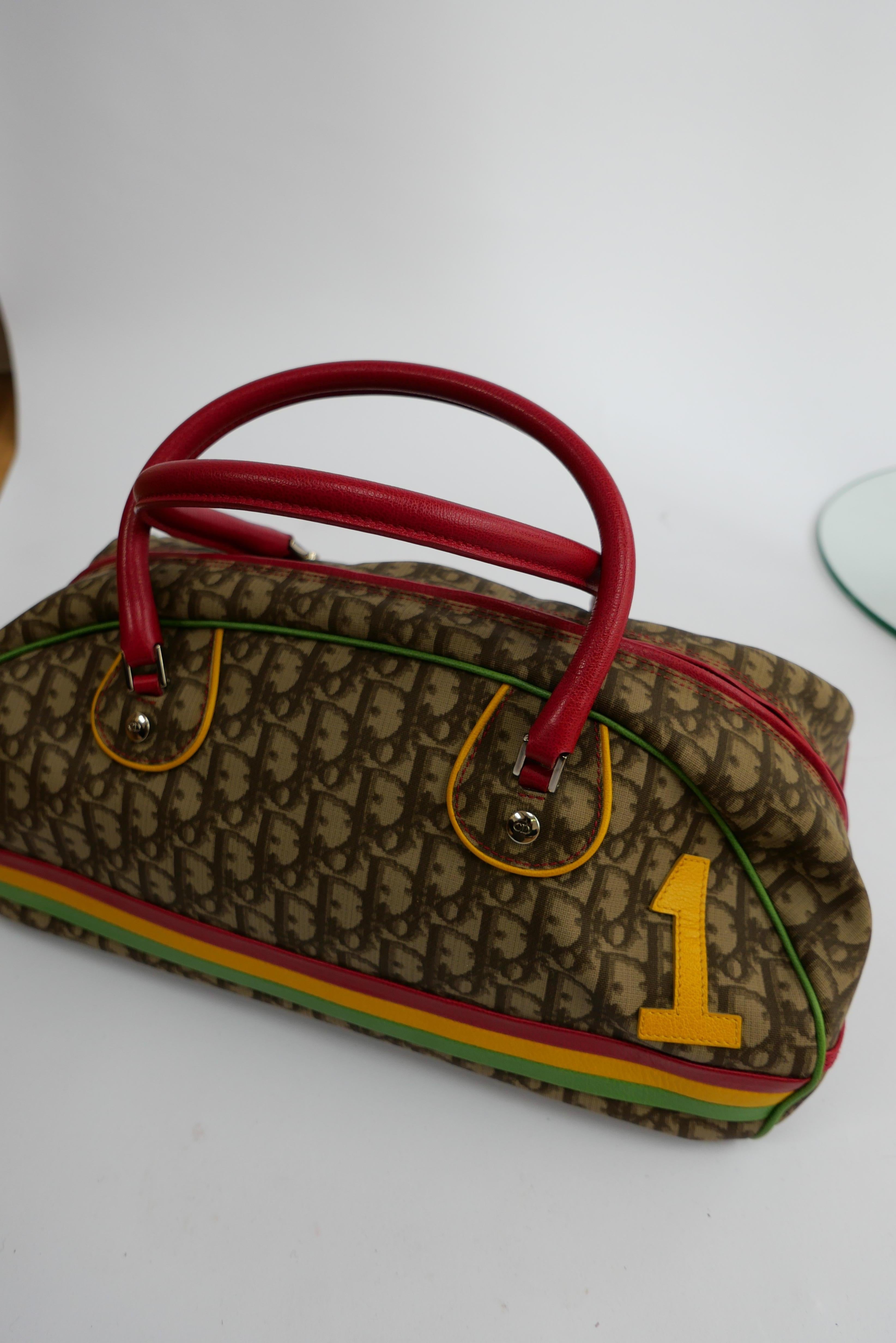 Christian Dior A/W 2004 Bag Rasta Collection 
This piece is from the Autumn Winter 2004 Dior collection designer by John Galliano. Galliano was inspired by Rastafarian's in Jamaica and uses the colours of the Rasta flag thoughout the collection and