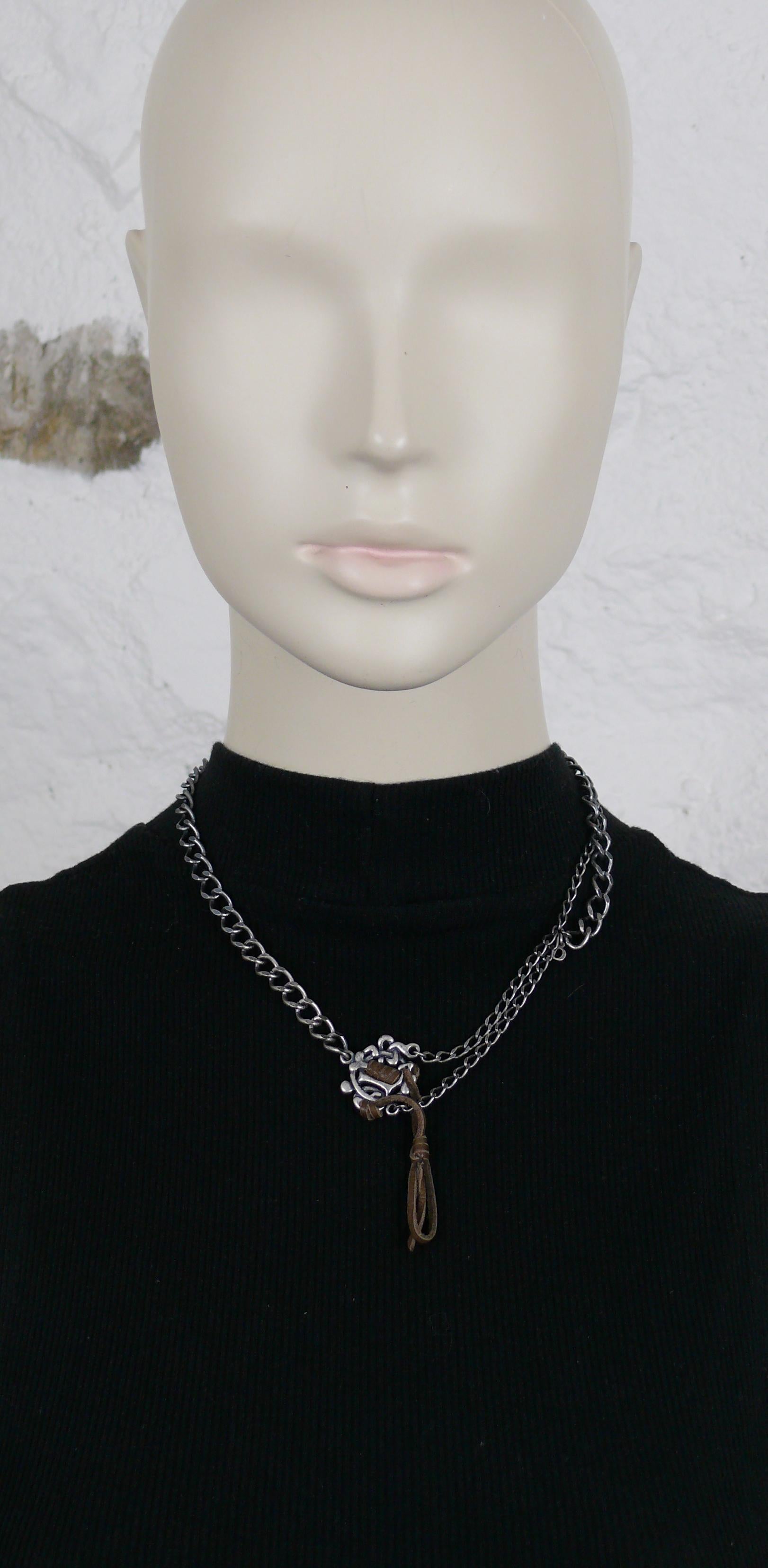 CHRISTIAN DIOR asymetrical antiqued silver toned chain necklace featuring a CHRISTIAN DIOR logo embellished with brown leather.

Silver tone metal hardware.

Adjustable lobster clasp closure.

Embossed DIOR.

Indicative measurements : adjustable