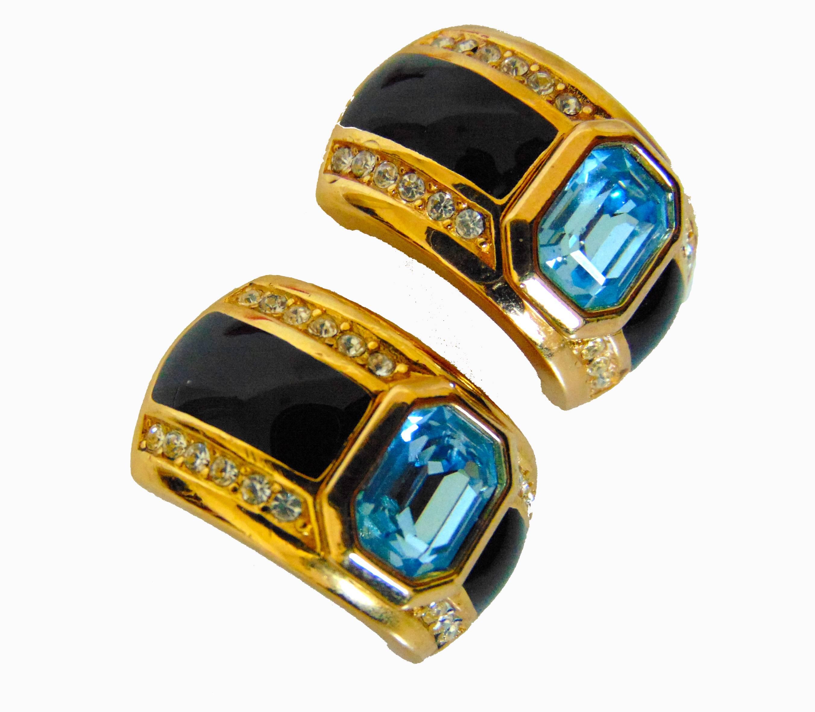 Authentic, preowned, vintage Christian Dior art deco earrings with faux sapphire topaz crystals, likely made in the 1980s.  Made from gold metal, these clip style earrings feature pretty topaz crystals in the center, with rich sapphire colored