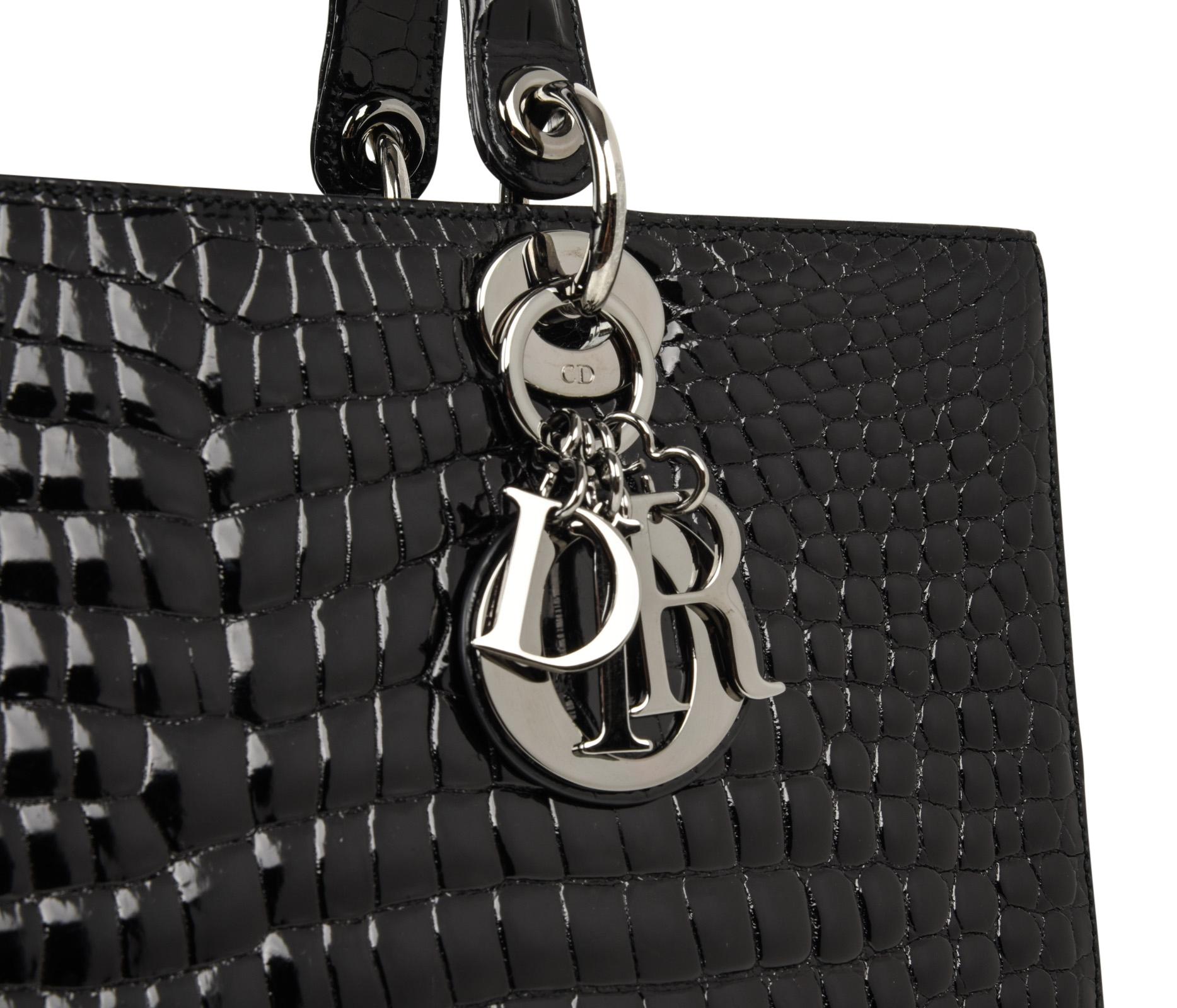Christian Dior Lady Dior large Black crocodile limited edition bag with ruthenium toned hardware.
Crafted by hand this is the flagship model.
Signature logo charms.
Top zipper closure with signature toggle.  
Zipper pocket on interior rear wall. 