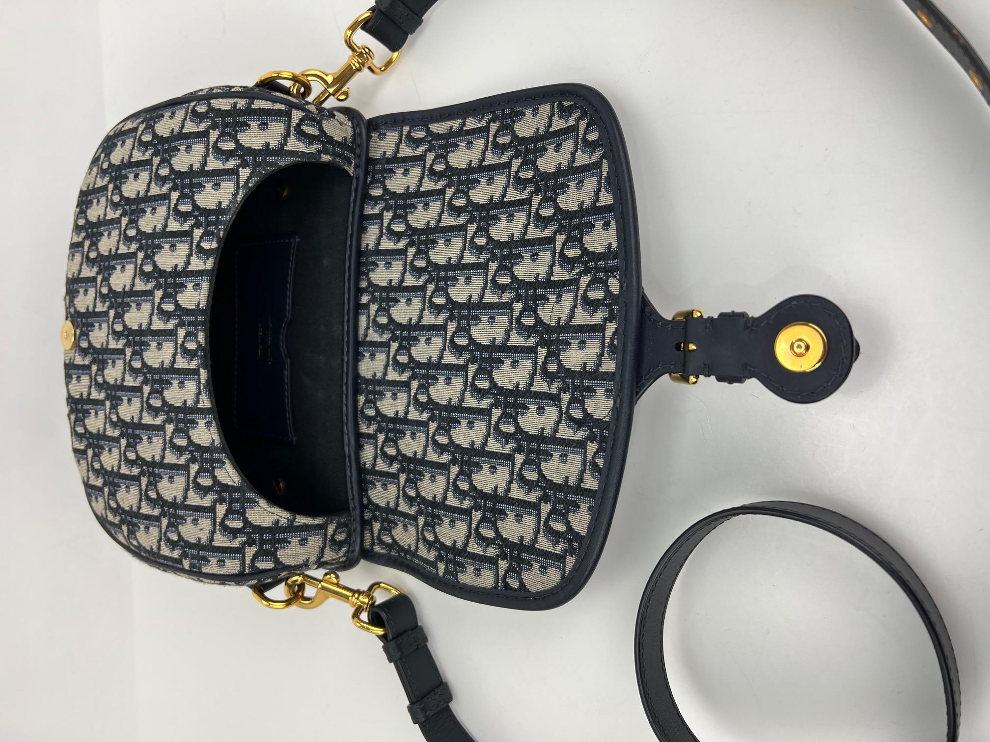 Pre-Owned  100% Authentic
Dior Oblique Jacquard Blue Medium
Bobby Flap Bag
RATING: A...excellent, near mint, only
slight signs of wear
MATERIAL: Dior Oblique jacquard, leather trim
STRAP: adjustable, removable leather
DROP: 19'' to 21''
COLOR: 