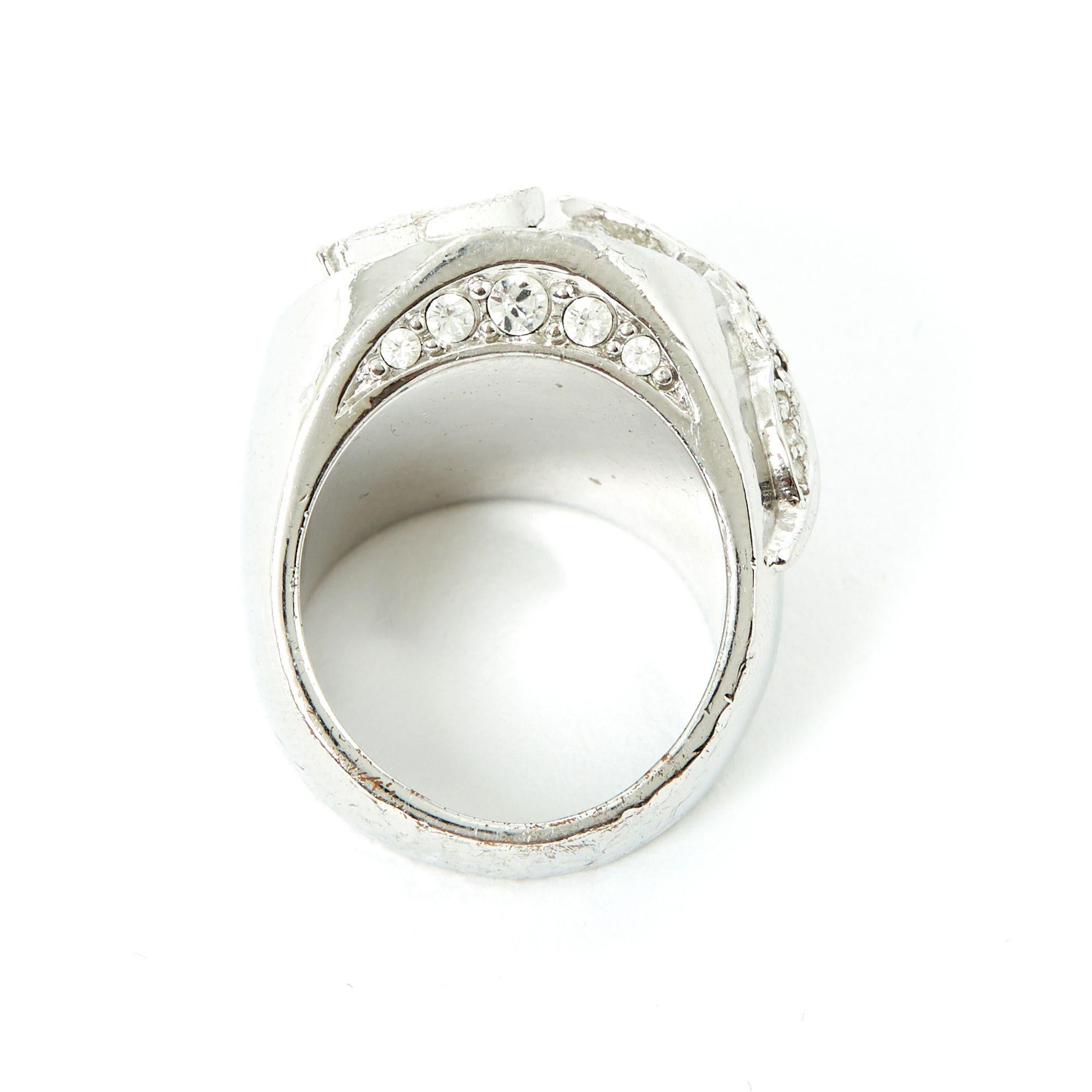 Dior signet ring in silver metal with a large oval central white rhinestone surrounded by rhinestones, topped with a Dior D paved with rhinestones and a feather also paved with rhinestones. Size indicated 6US or 52FR but measurements indicate 50FR,