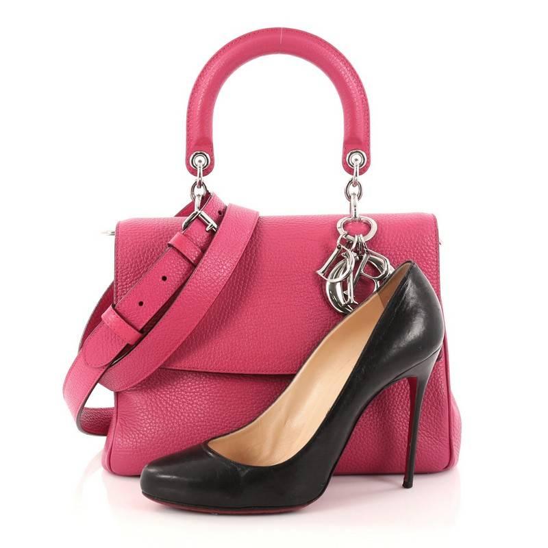 This authentic Christian Dior Be Dior Bag Pebbled Leather Small is both bold and beautiful, perfect for every fashionista. Crafted from pink pebbled leather, this boxy bag features a leather handle with sleek silver Dior charms, side snap button,