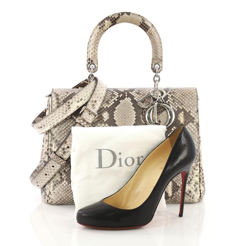 This Christian Dior Be Dior Bag Python Medium, crafted from genuine brown and beige python skin, features python skin handle with Dior charms, an exterior back slip pocket, and silver-tone hardware. Its flap opens to a brown leather interior with