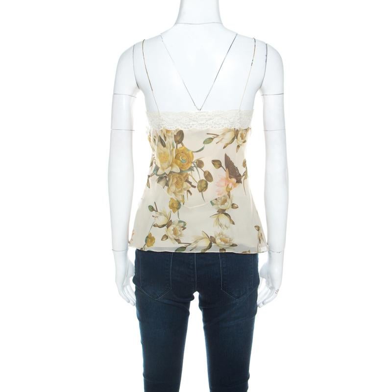 This sleeveless camisole top from Christian Dior is perfect to complement your chic style! The top features thin straps, lace trims and floral prints in multiple colours all over. Pair it with skirts or jeans for a casual day out.

Includes: The