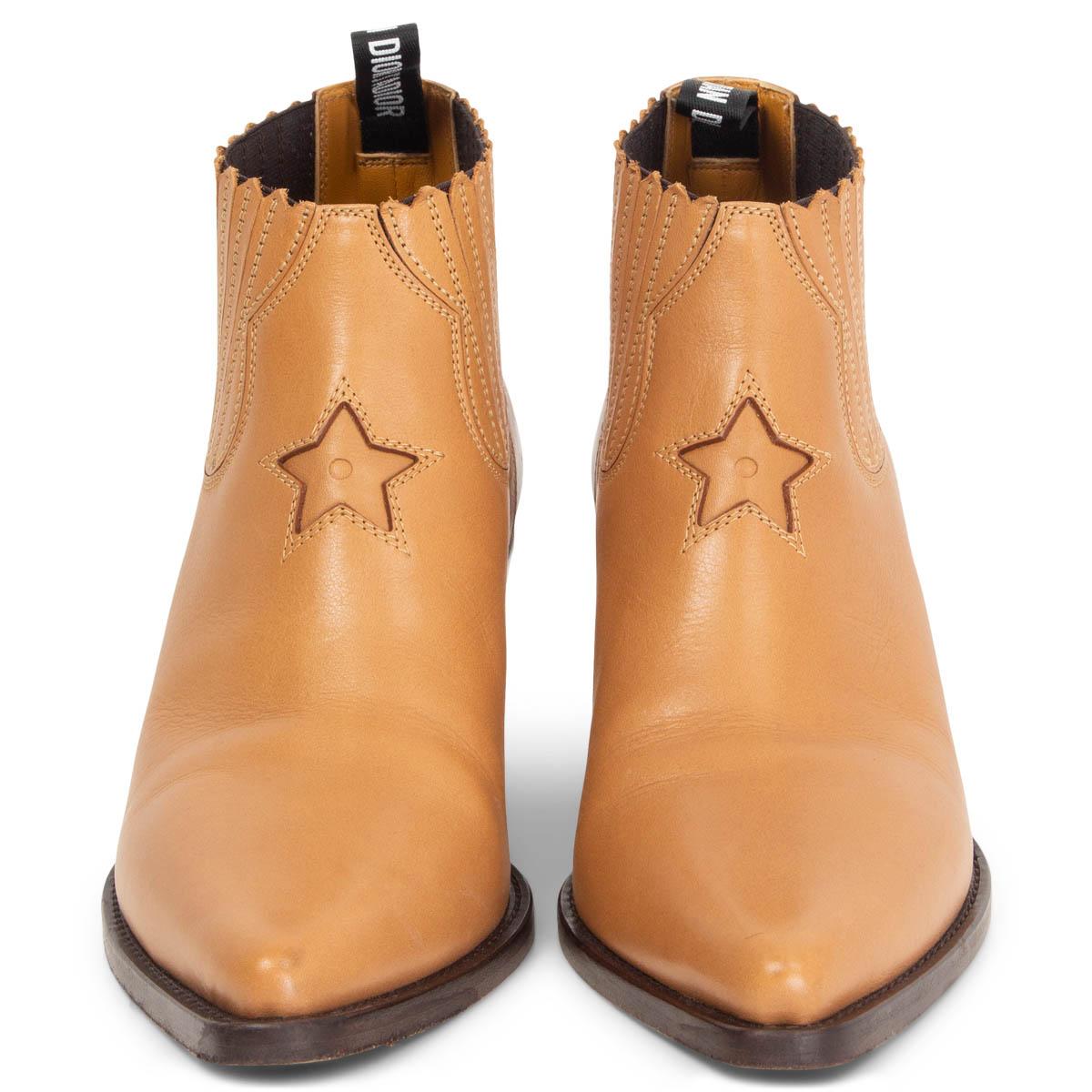 
100% authentic Christian Dior star ankle cowboy boots in beige and calfskin featuring a pointed toe and logo pull tab at the rear with decorative star detail to the front. Elastic inserts on the side. Have been worn and are in excellent condition.