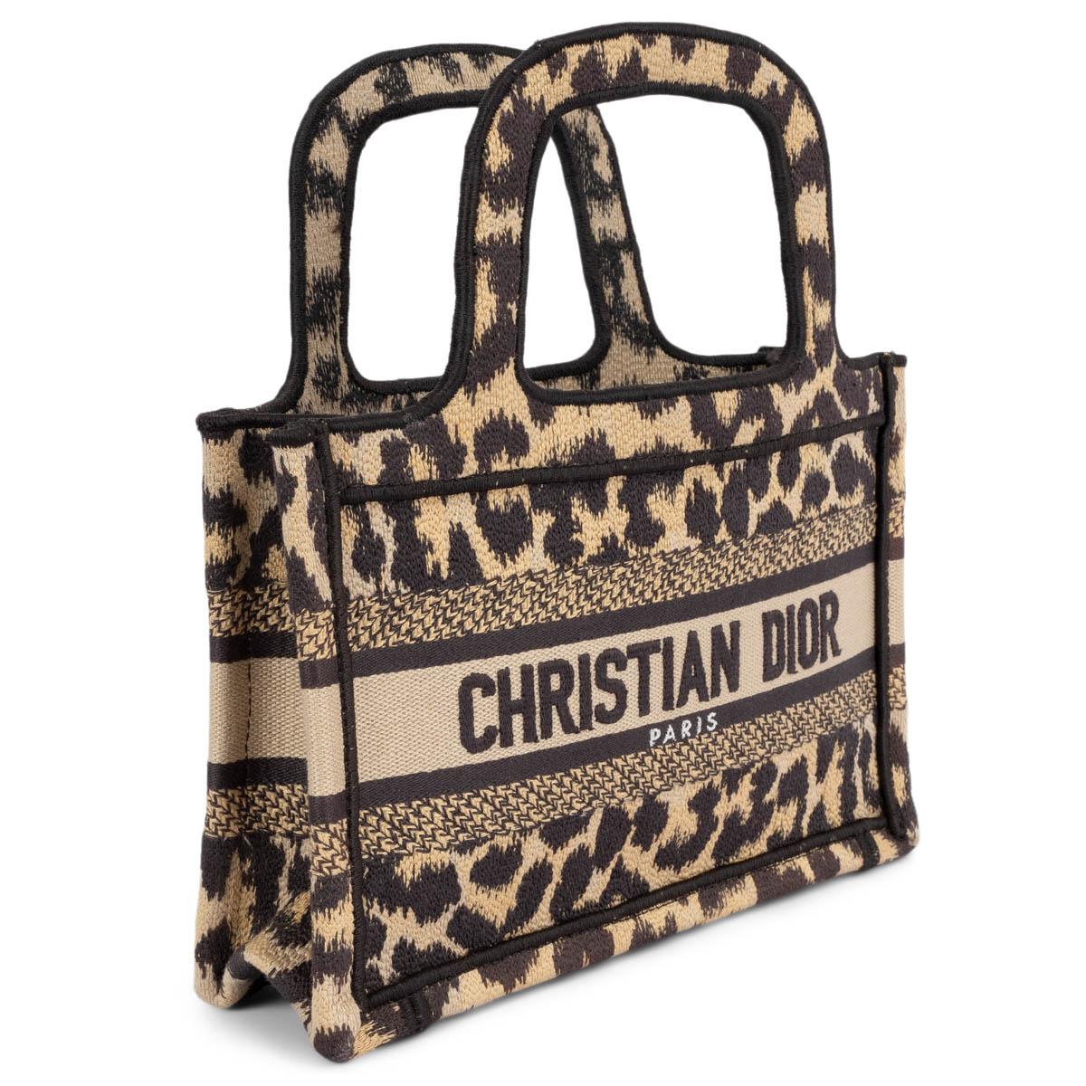100% authentic Christian Dior Mini Book tote in beige and black leopard mizza embroidered canvas. Features logo embroidered on the front and features an opens top that leads to a matching fabric interior. Has been carried once and is in virtually