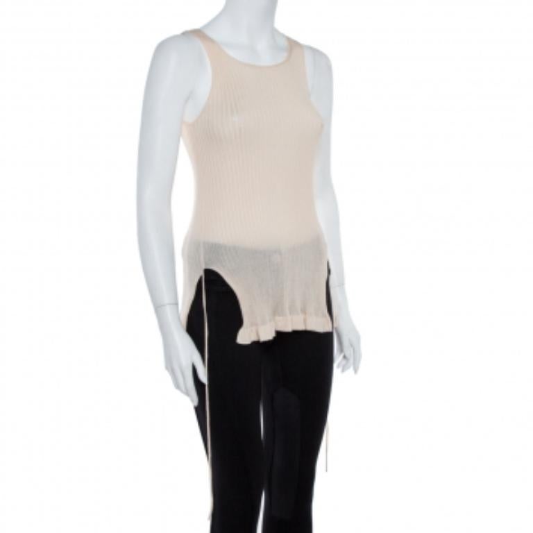 Exhibiting a chic style, this sleeveless Christian Dior top is a statement-making piece! The wool blend creation features a flattering silhouette that is enhanced with a round neckline and cut-out bottom hems with tie details. It is sure to lend you