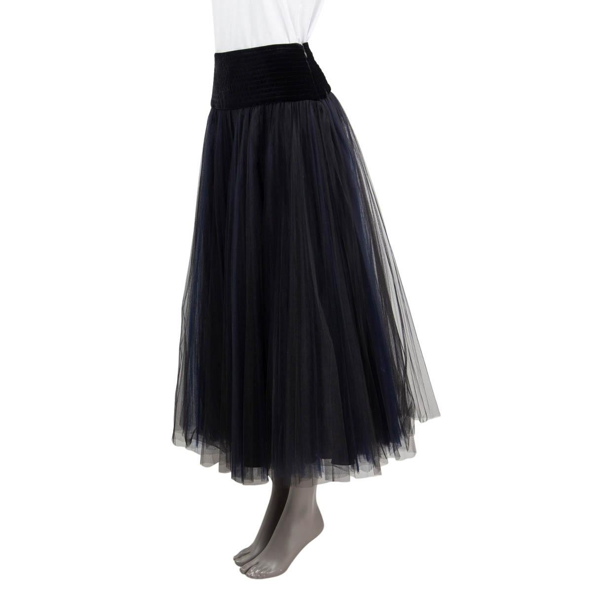 100% authentic Christian Dior Fall/Winter tulle midi skirt in black and navy polyamide (100%). Features a velvet waist in black viscose (80%) and silk (20%). Opens with a concealed zipper and a hook on the side. Lined in black silk (100%). Has been