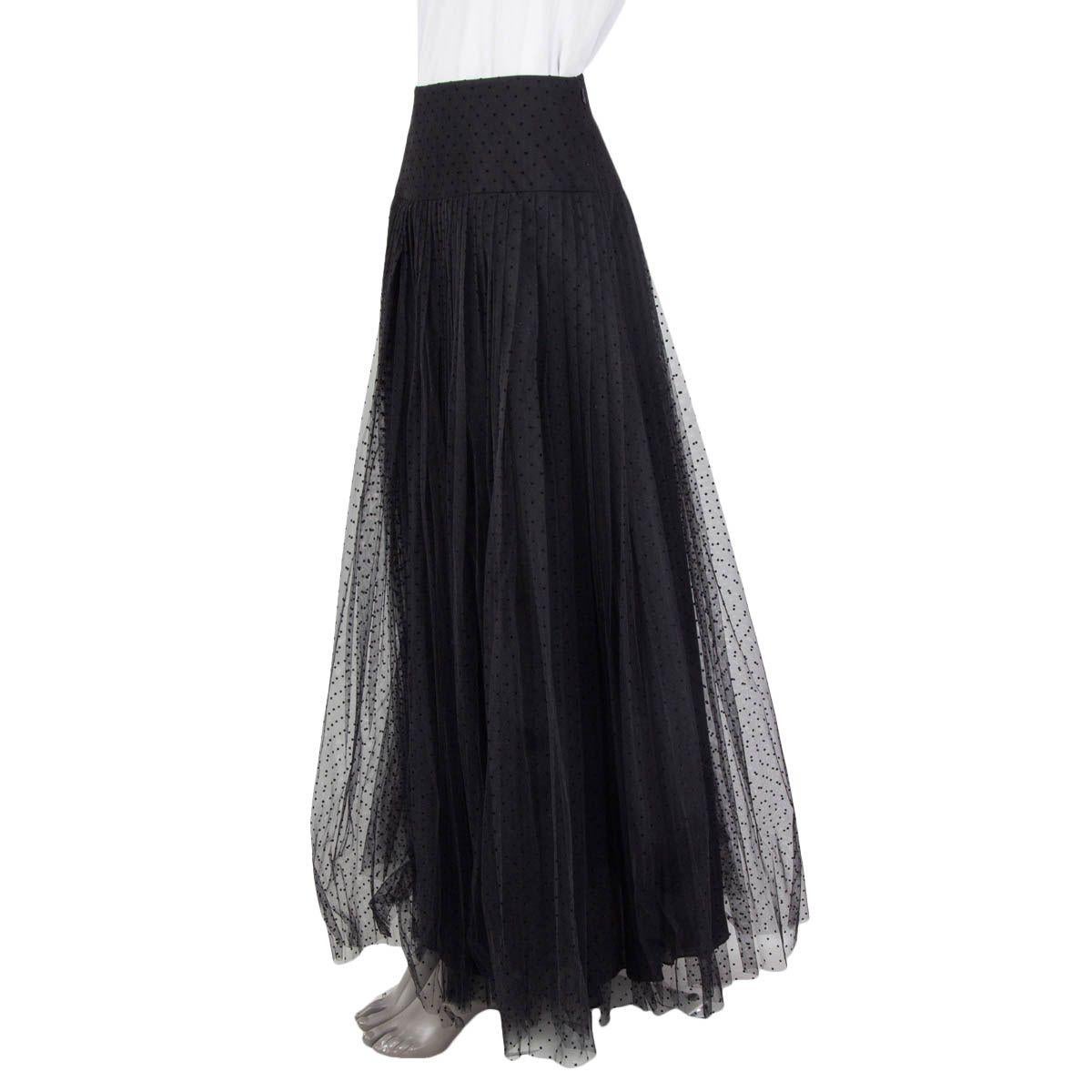 100% authentic Christian Dior 2020 pleated dotted tulle midi skirt in black polyamide (100%). Opens with a concealed zipper and a hook at the side. Lined in black silk (100%). Has a tear at the hemline otherwise in excellent