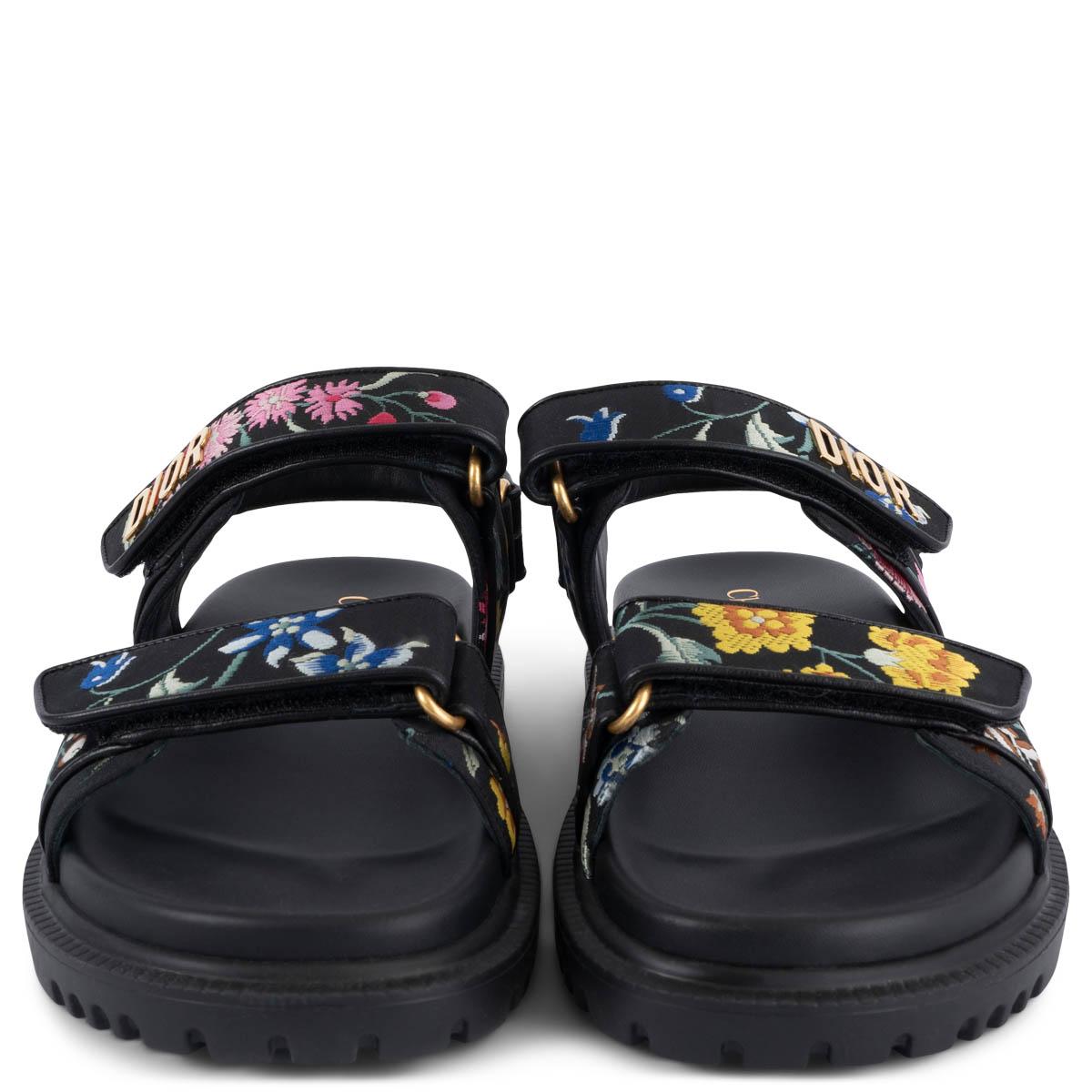 100% authentic Christian Dior 2023 DiorAct sandals in black calfskin and technical fabric embroidered with Dior Petites Fleurs motif. The design features gold-finish metal 'DIOR' signature, two adjustable scratch straps, a anatomically shaped