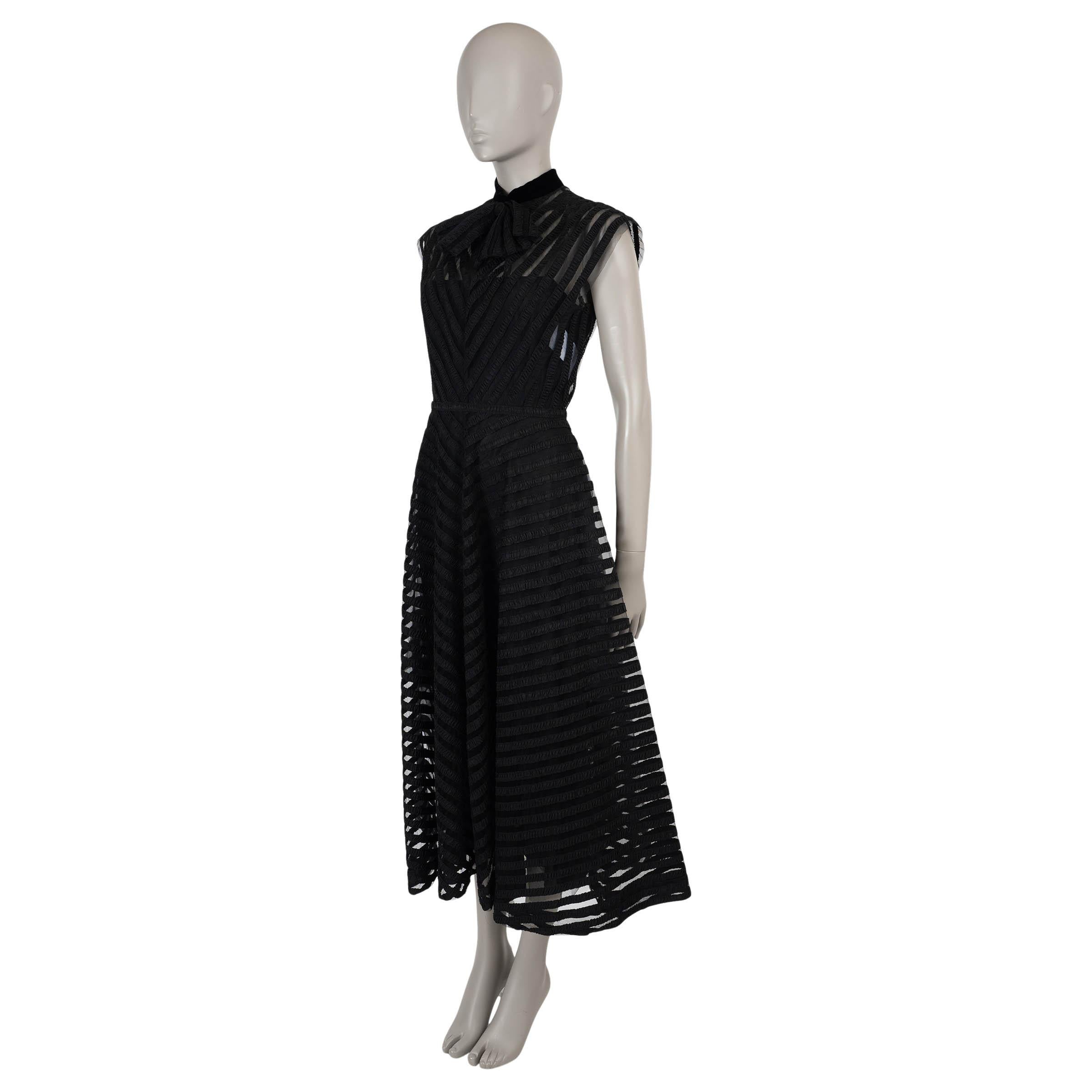 This 100% authentic Christian Dior dress in black tulle polyamide (100%) is intricately embroidered with black ribbons, creating a delicate yet structured design. Featuring a fit and flare silhouette with a midi length, it is elevated by a velvet
