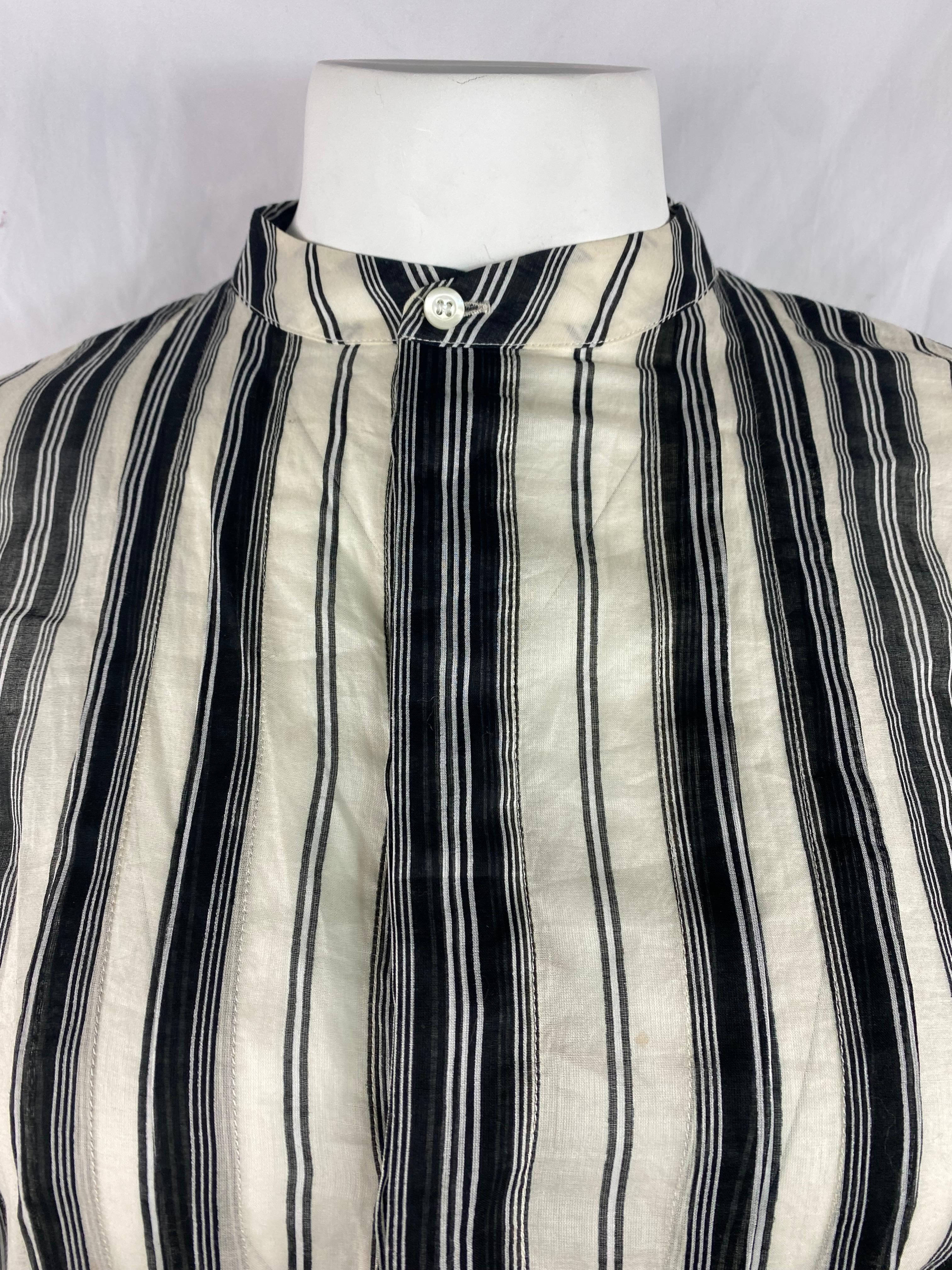 Product details:

The top is made out of 100% cotton, it features black and white striped print with front button half down closure.
