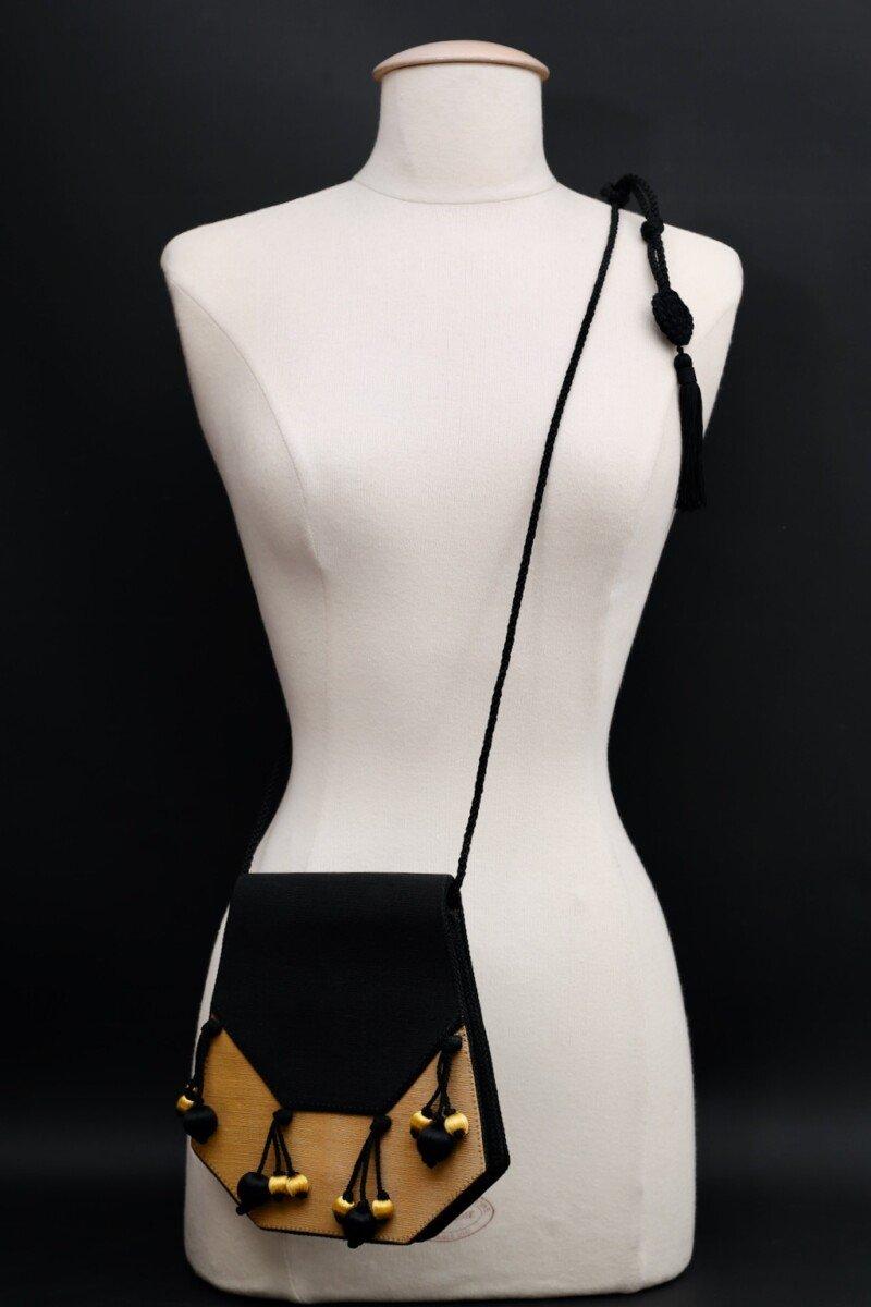 Christian Dior (Made in France) Shoulder strap bag composed of black and yellow ottoman fabric. It features a black passementerie trimming, passementerie details on the handle, and yellow and black pendants. 
It is lined with black suede.