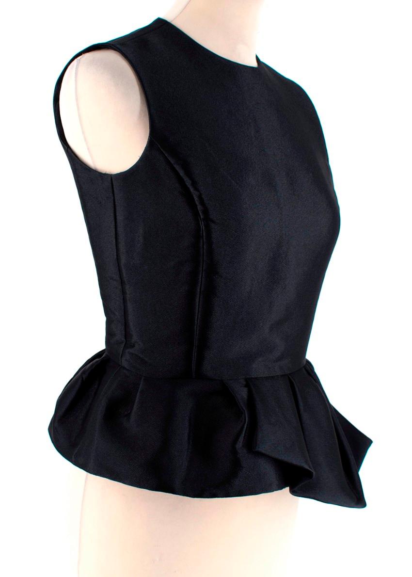 Christian Dior Black Asymmetric Peplum Blouse

- Heavy weight fabric with sheen 
- Layered, ruffled peplum
- Opening at top of back with button fastening 
- Size zip fastening

Materials
57% Polyester
43% Silk
Lining 100% Silk

Dry Clean Only

Made