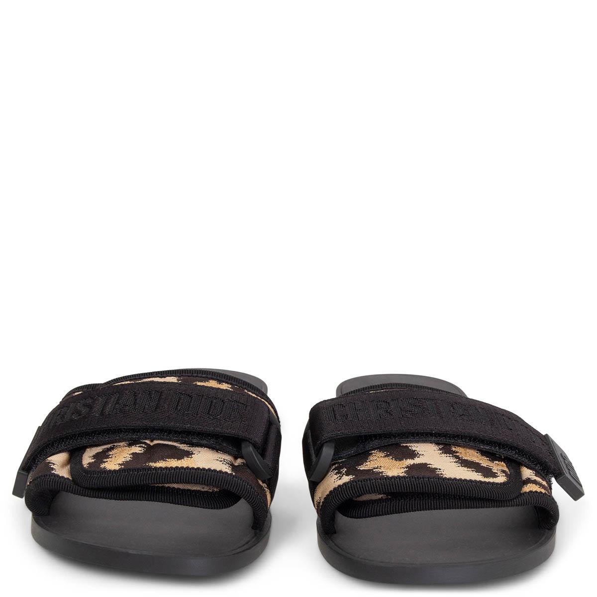 100% authentic Christian Dior Dio(r)evolution slide in black and beige jacquard leopard technical fabric with a adjustable nylon strap that features 'CHRISTIAN DIOR' signature. Black rubber sole. Brand new. Come with dust bag.
